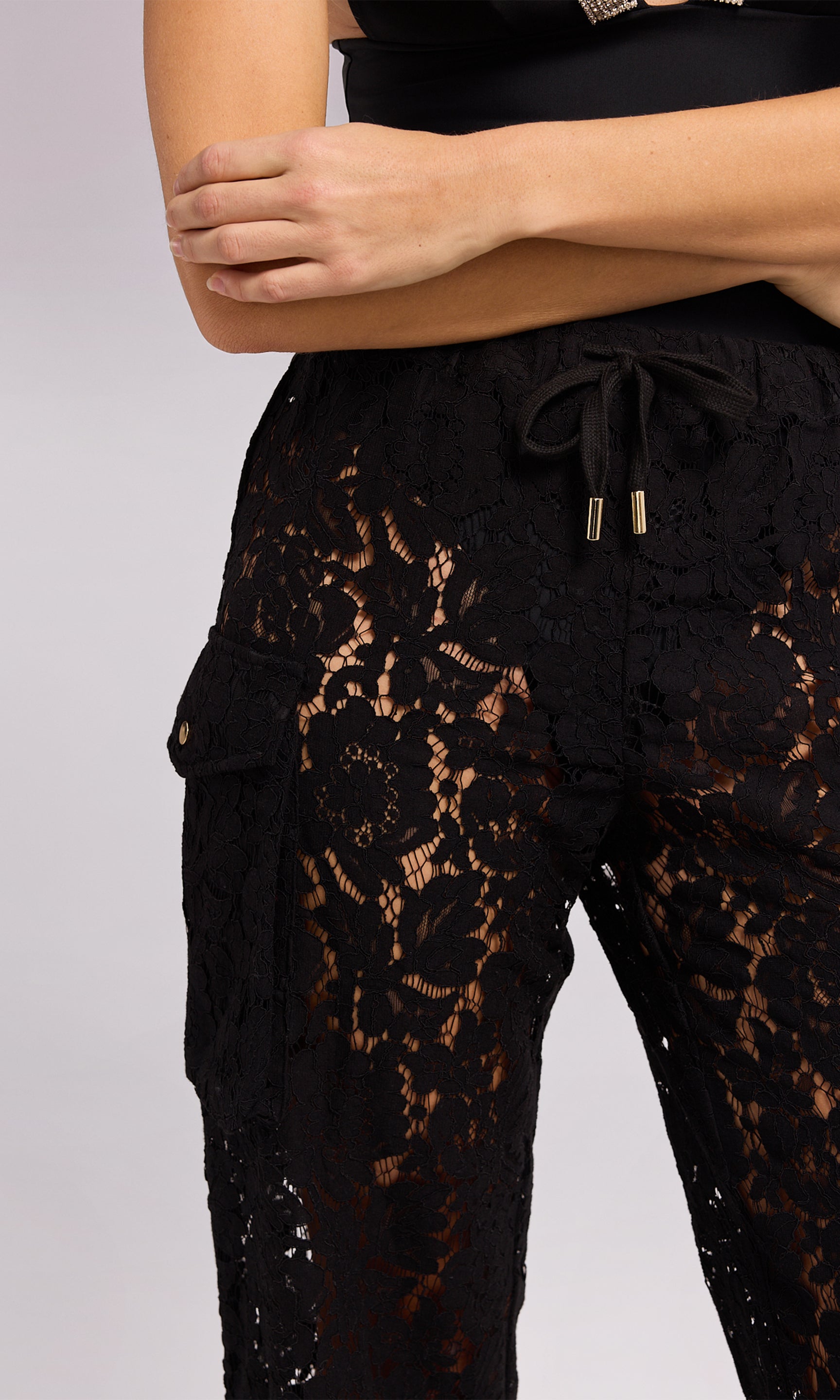 Palmer Lace Cargo Pant in black lace, showcasing a fashionable and eye-catching style for any outfit.