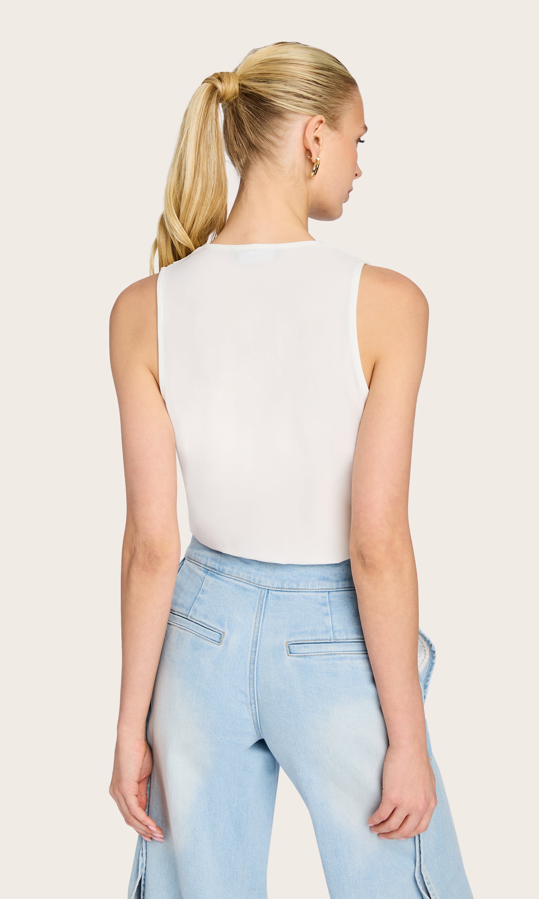 Rear view of the model in the Ansel Bodysuit, emphasizing the smooth back and body-hugging fit.