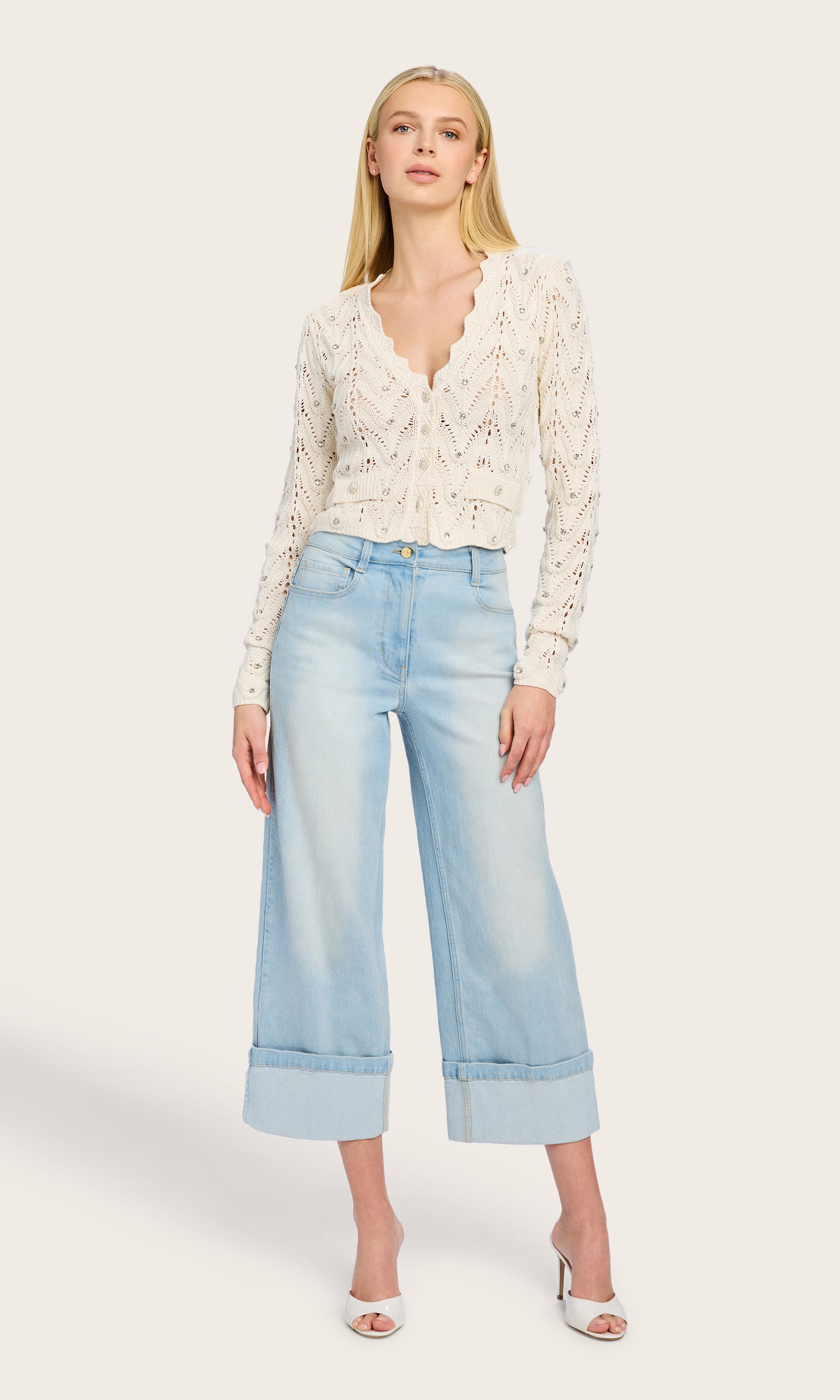 Full body image of the Blake Crystal Pointelle Cardigan as the model pairs it with wide-leg denim for a modern, effortless summer look.