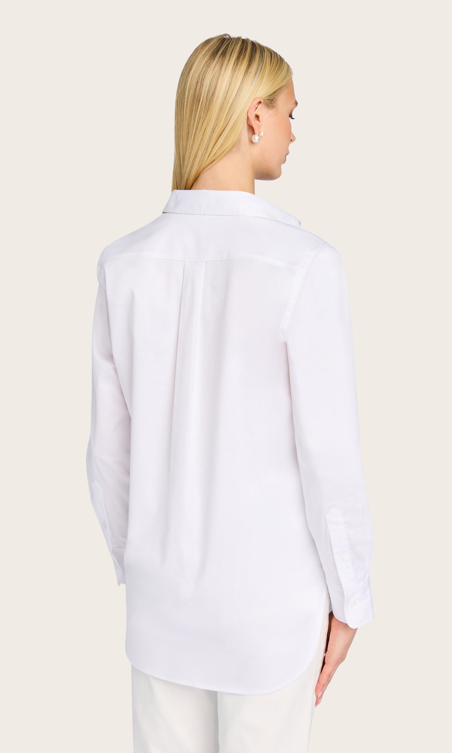 From the back, the model highlights the clean structure and relaxed boyfriend fit of the Bruno Emb Poplin Shirt.