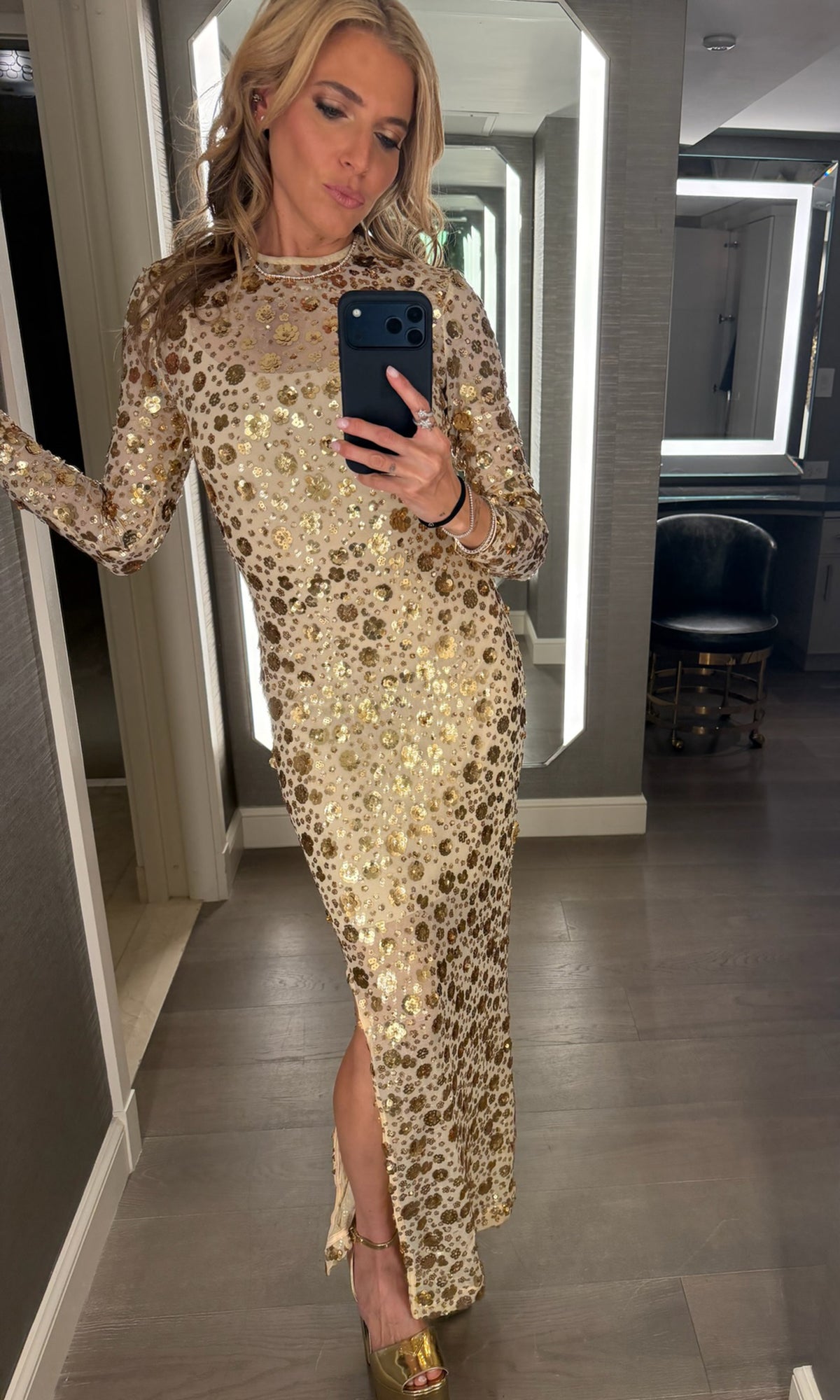 Our founder Roni wearing a beige dress with gold floral sequins embellishments.