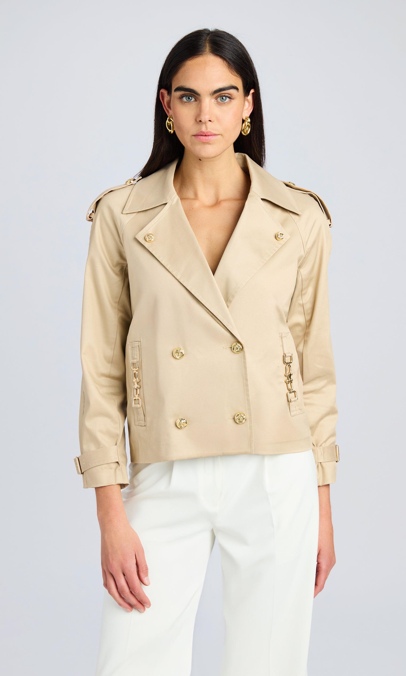 Front view showing the model wearing the structured jacket, highlighting its tailored fit and double-breasted design.