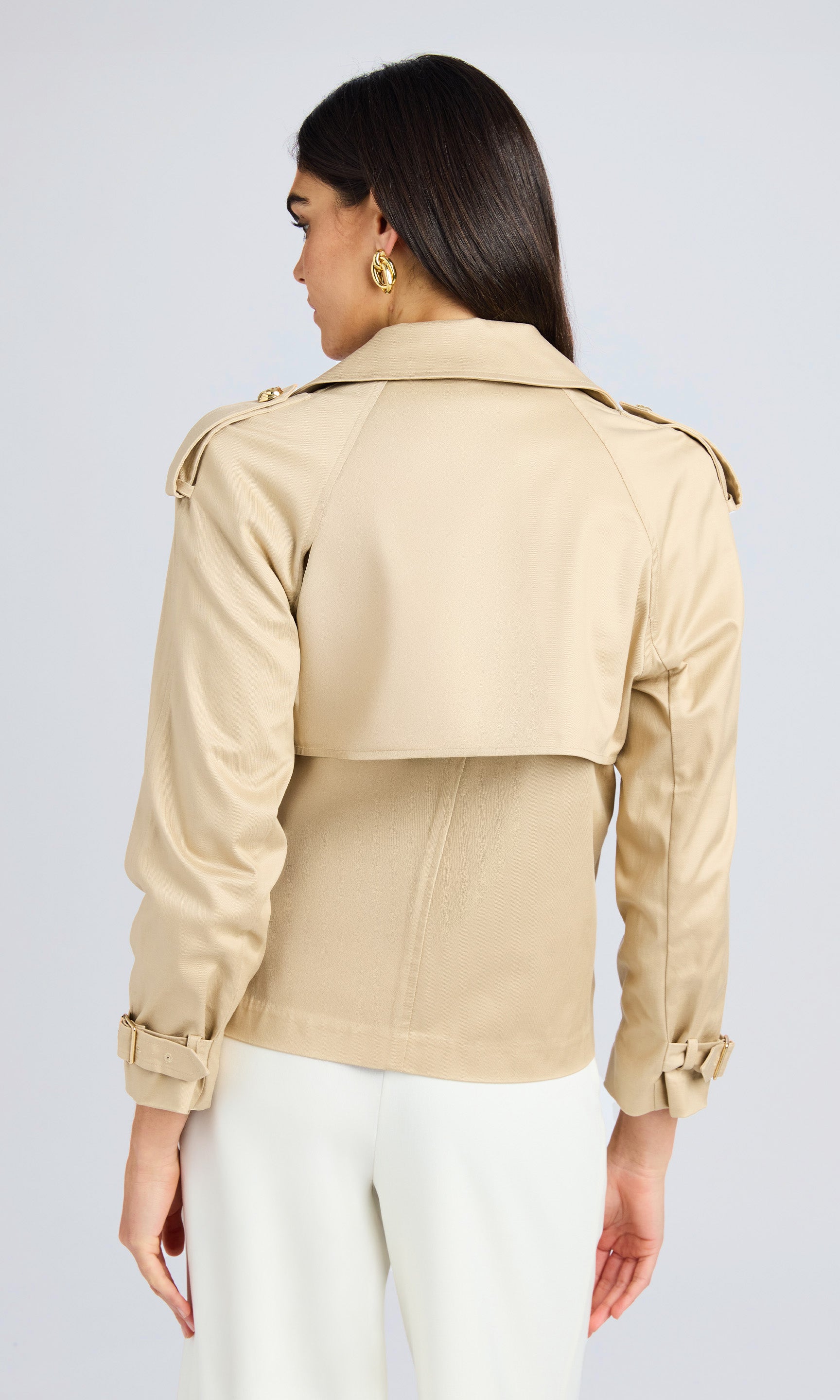 Rear view displaying the back details of the jacket, emphasizing its structured shoulders and relaxed fit.