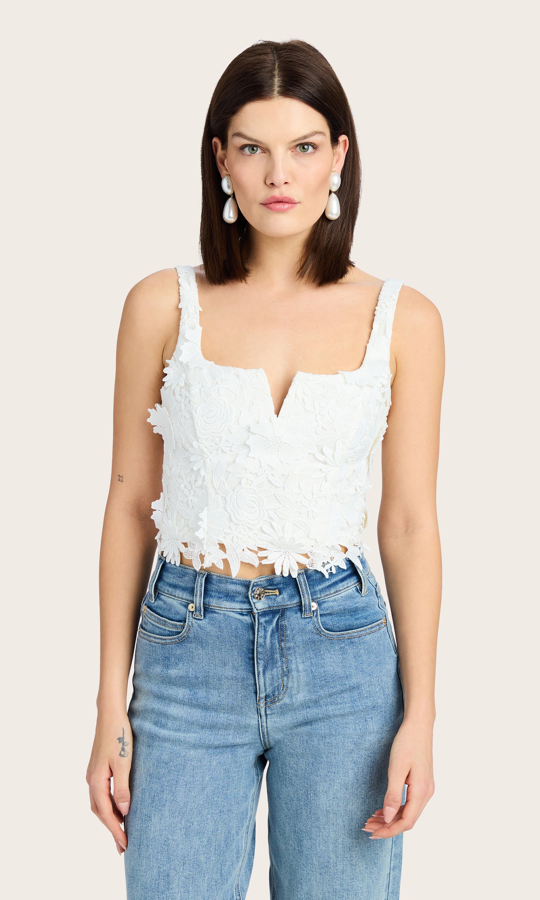 Front view of the Cassidy 3D Lace Bustier Tank styled with denim for a soft casual look
