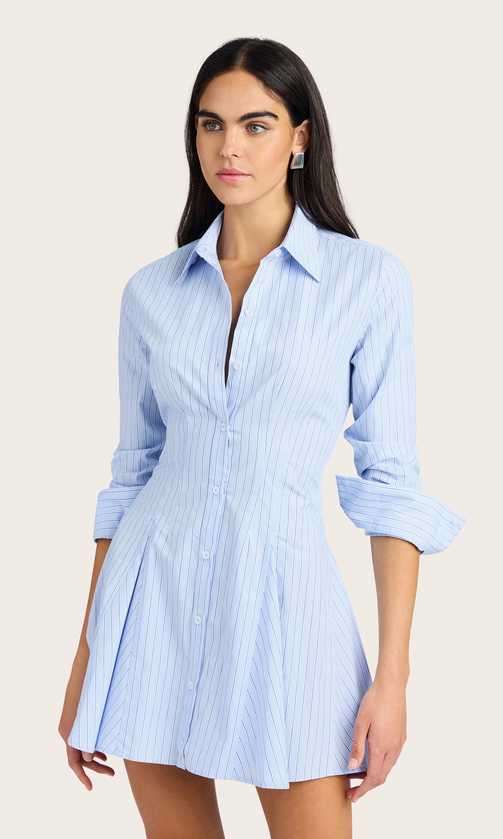 Model wearing the Clemente Pinstripe Poplin Dress with rolled sleeves, showing the cinched waist and mini skirt silhouette.