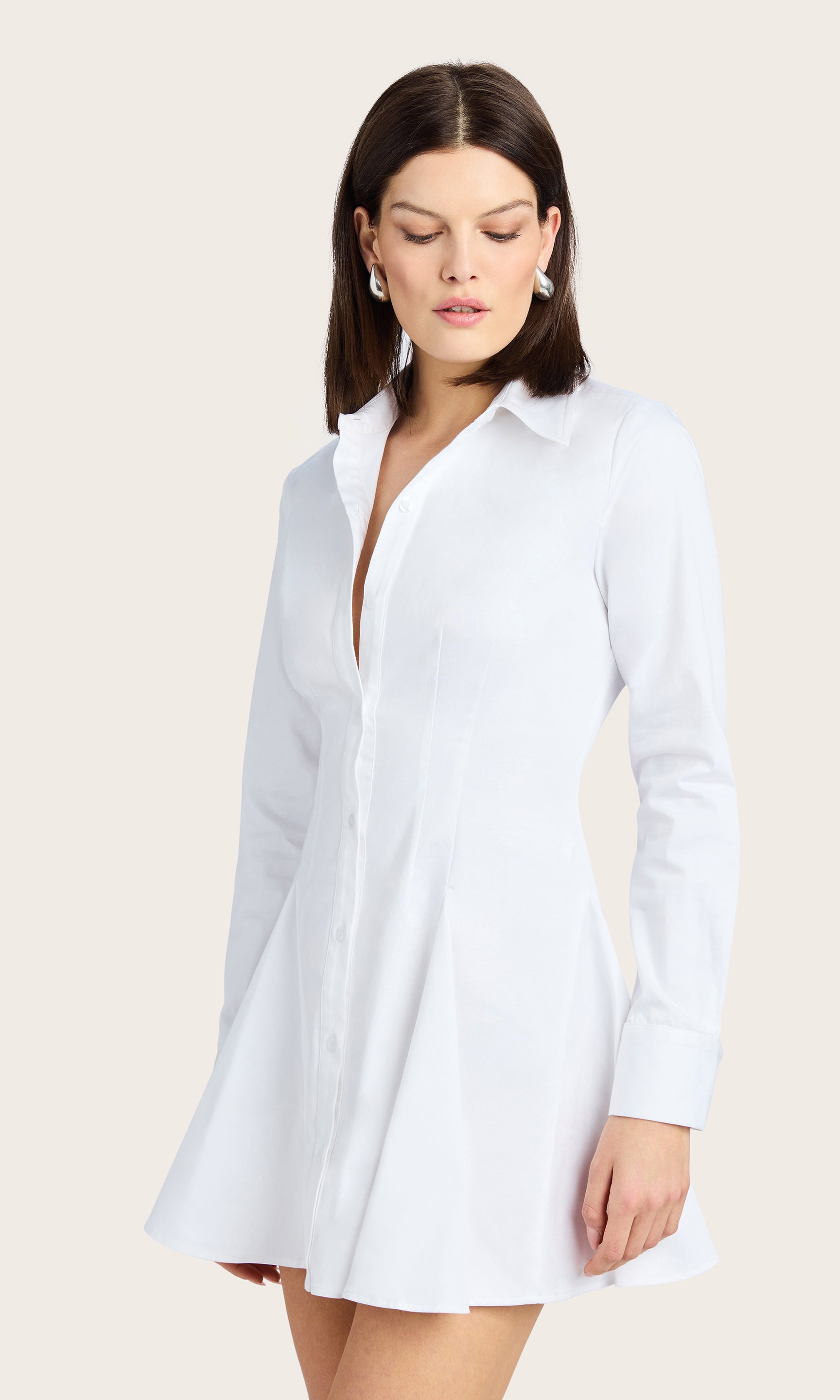 Back angled view of the Clemente Cotton Sateen Dress worn by the model, revealing the relaxed drape and minimal seam detail.