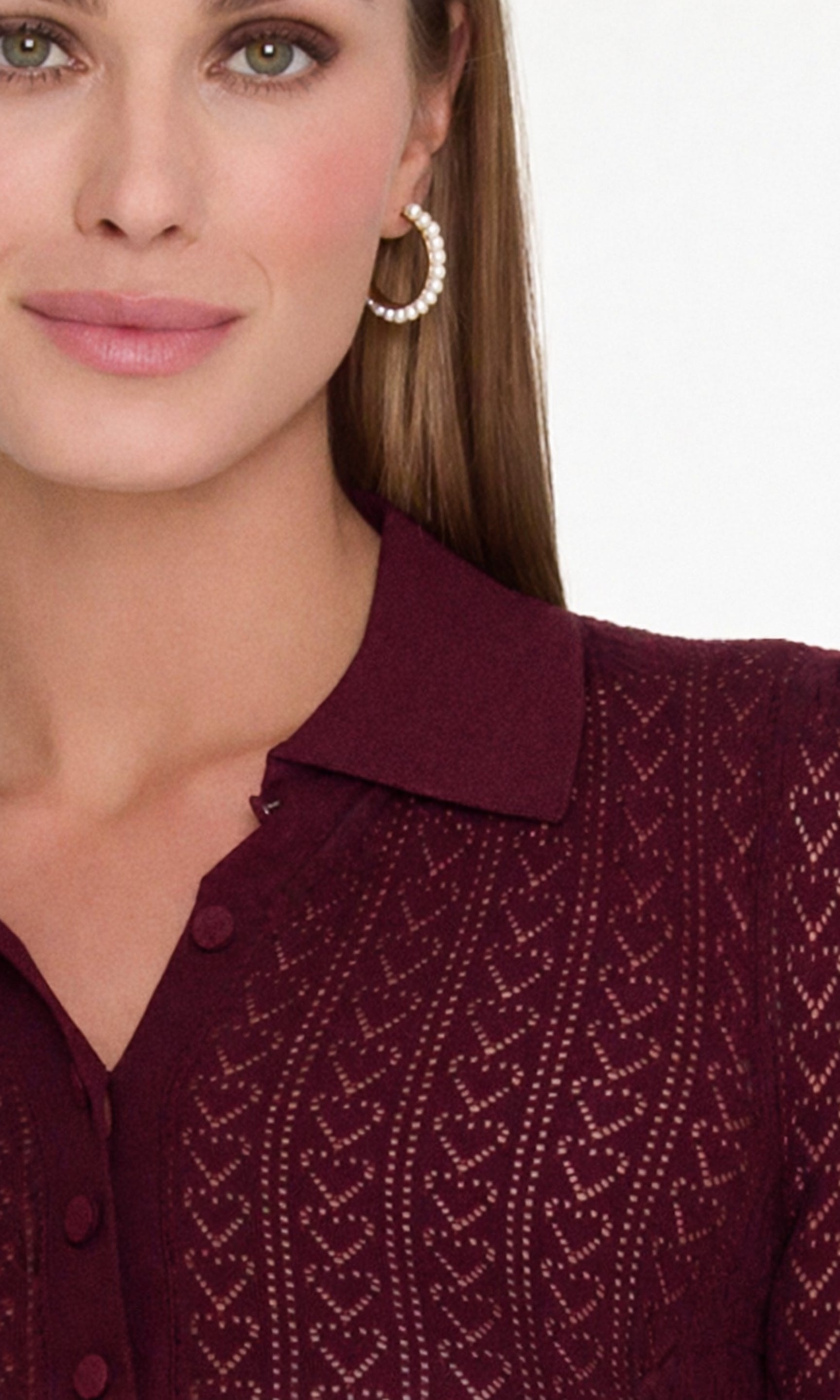 Woman wearing a malbec pointelle sweater with a heart design