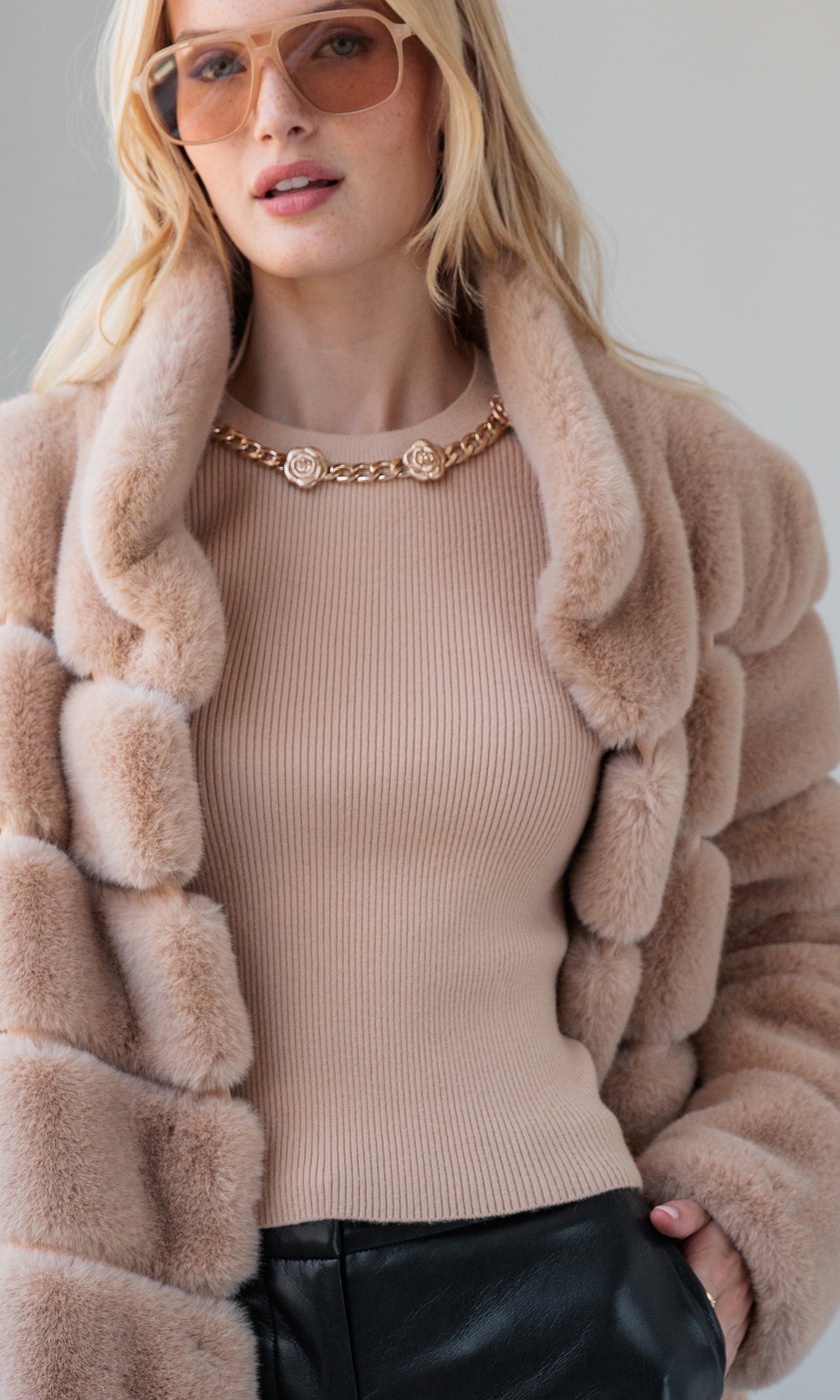 Layered look featuring the Leiber Rib Sweater With Poplin Cuff under a light brown puffer jacket, styled with black leather pants.