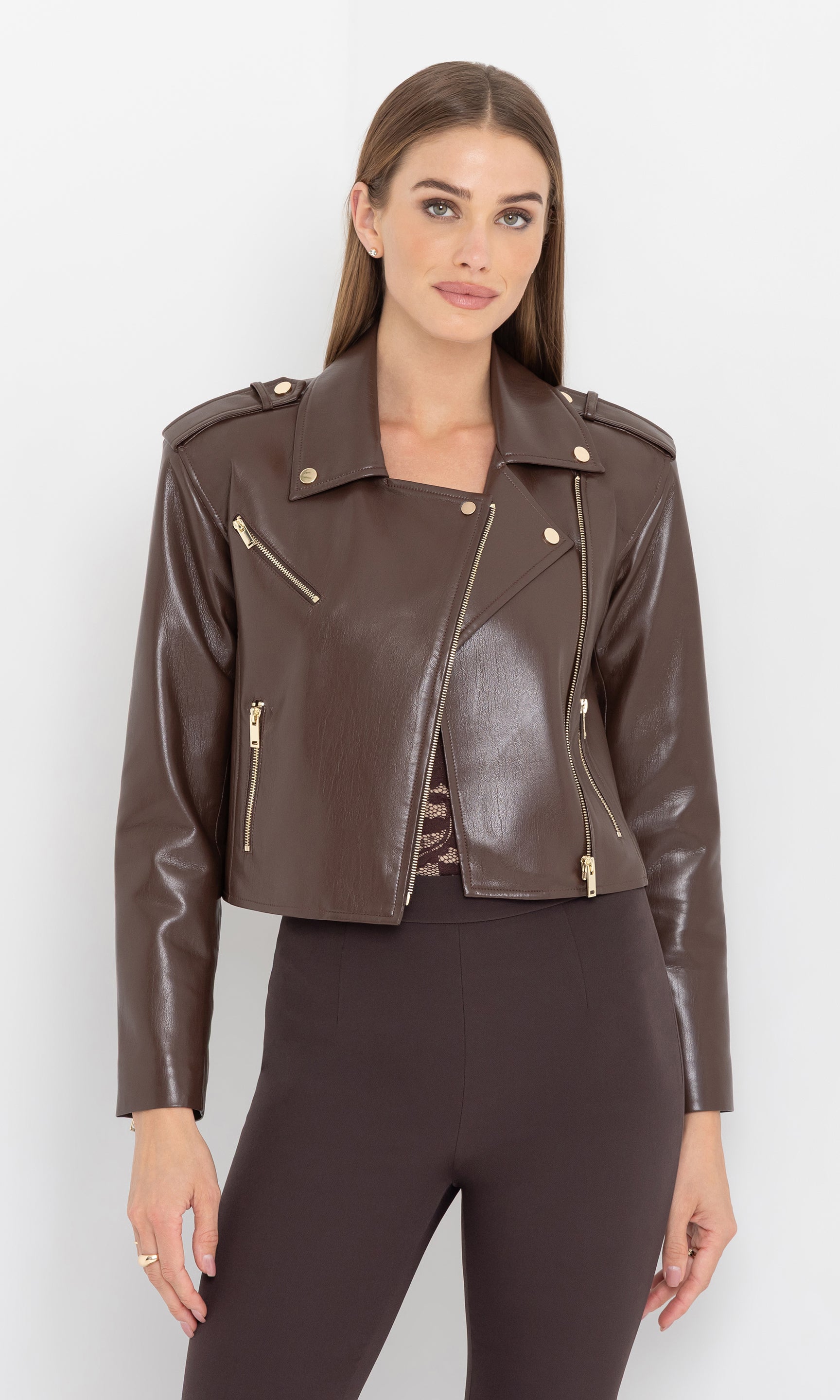 Front view of the cosita vegan leather jacket worn open over a top.
