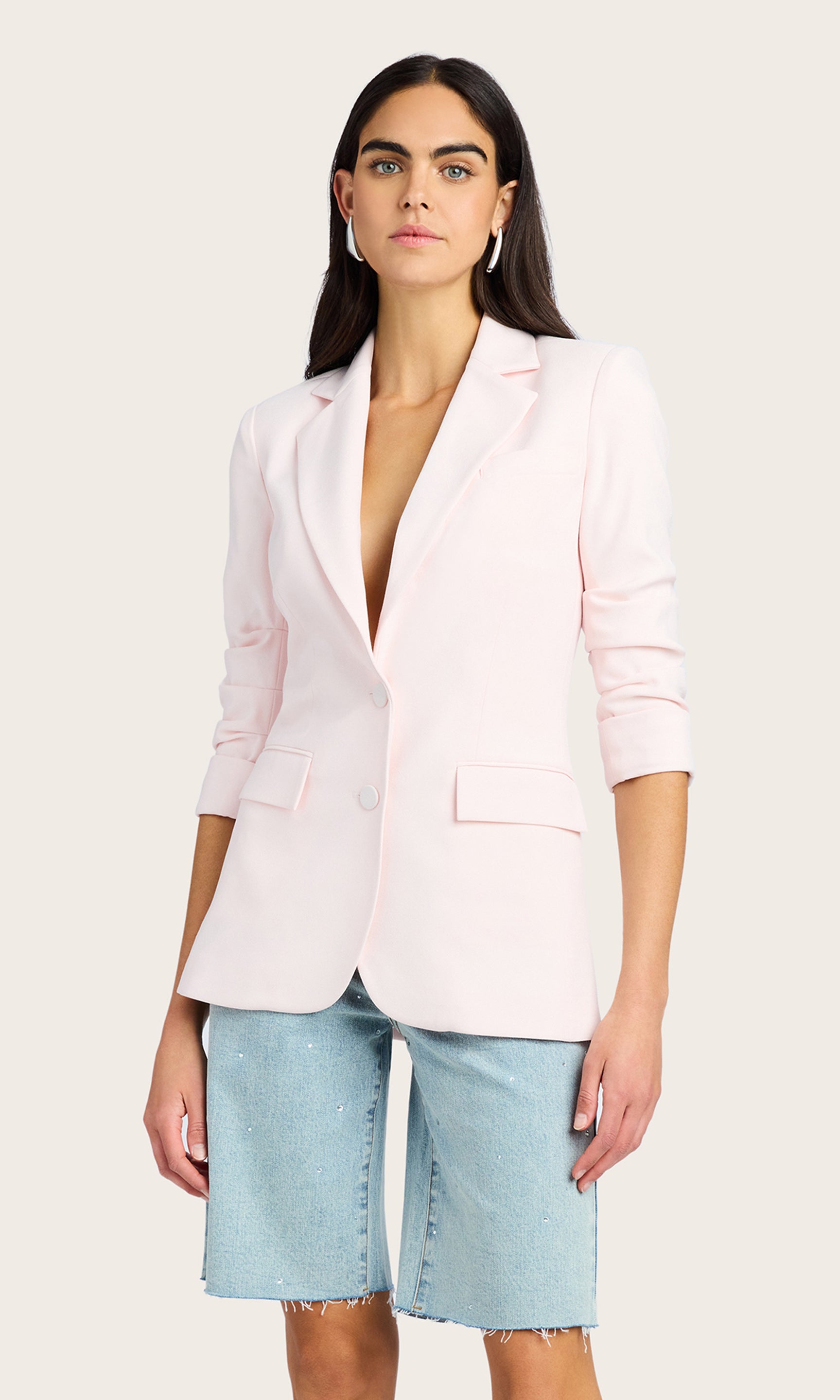 Front view of the model in the Drea Light Weight Crepe Blazer paired with light denim shorts and a white top.