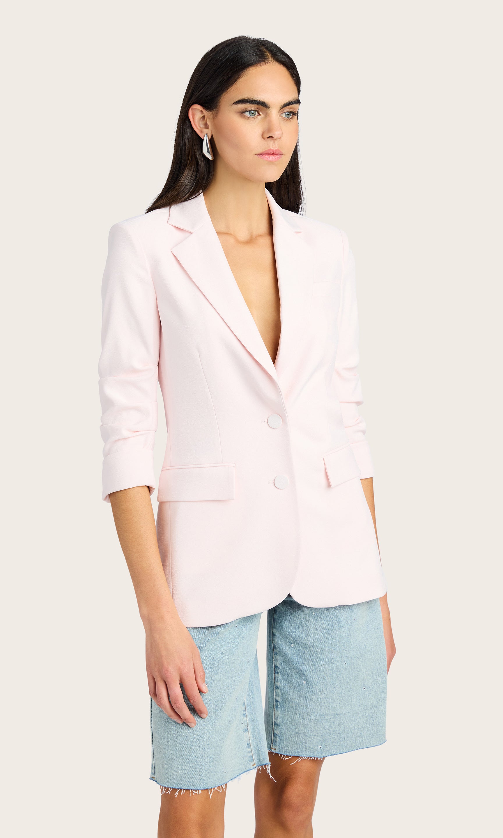 3/4 front view of the model in the Drea Light Weight Crepe Blazer paired with light denim shorts and a white top.
