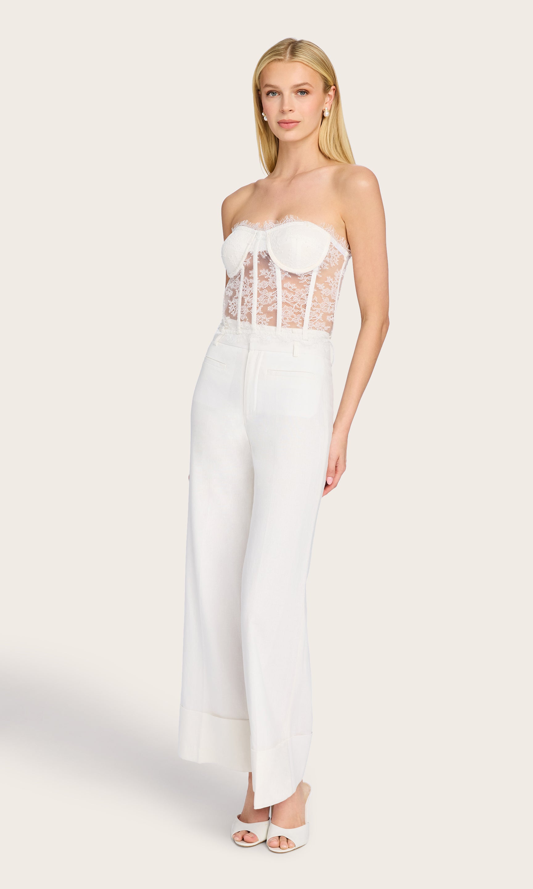 Full body view of the Raquel Linen Pants paired with a fitted sleeveless top, showcasing their effortless drape and cuffed hems.