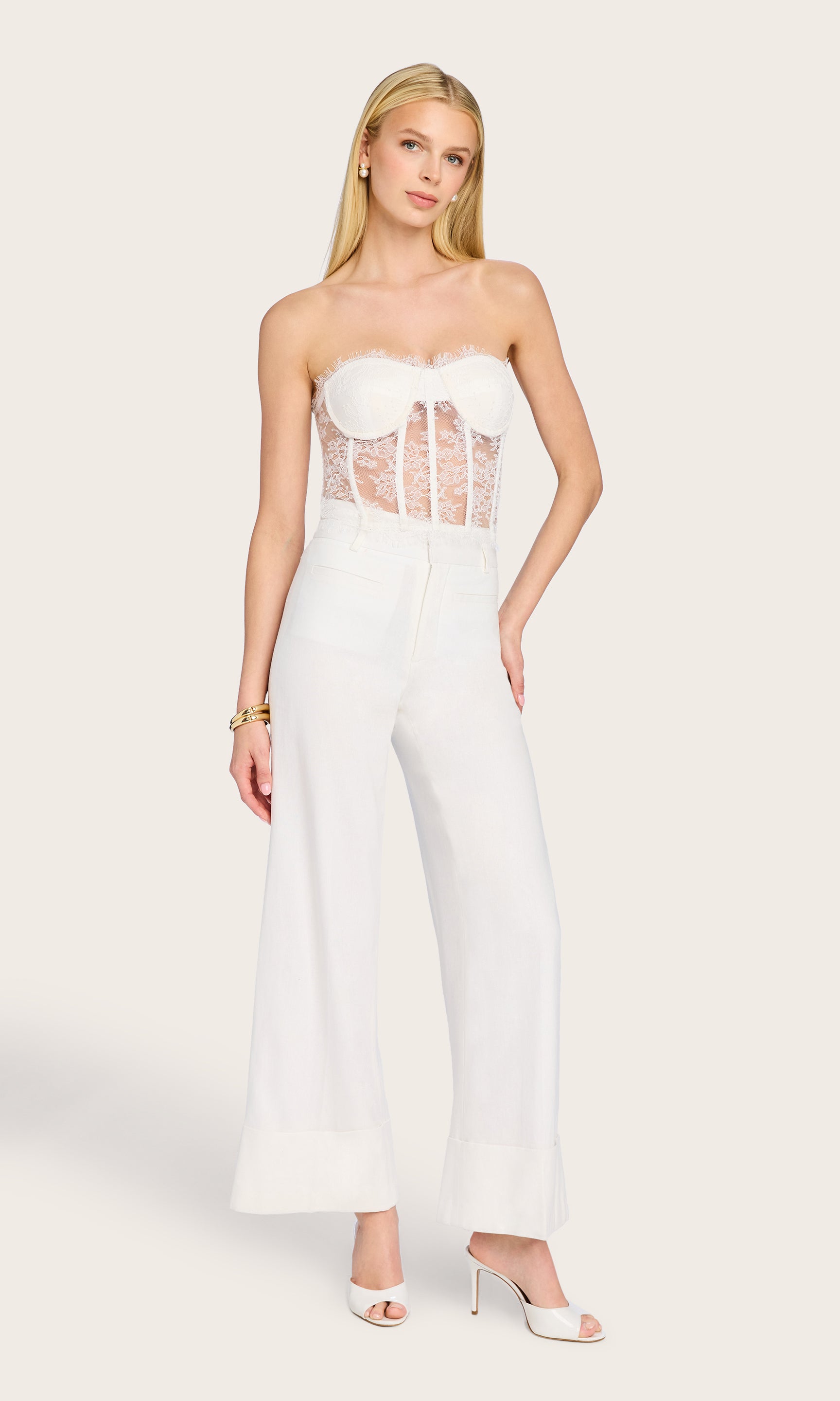 Full body image of the model wearing the Enya Chantilly Lace Bustier and wide-leg pants, styled with sunglasses and a confident pose.