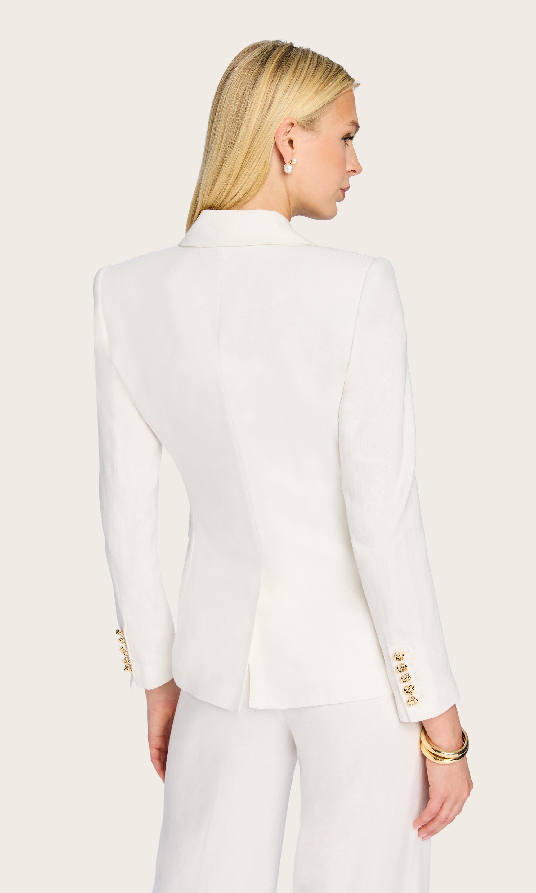 Rear view of the Arielle Linen Blazer showcasing the structured shoulders and straight-cut silhouette.