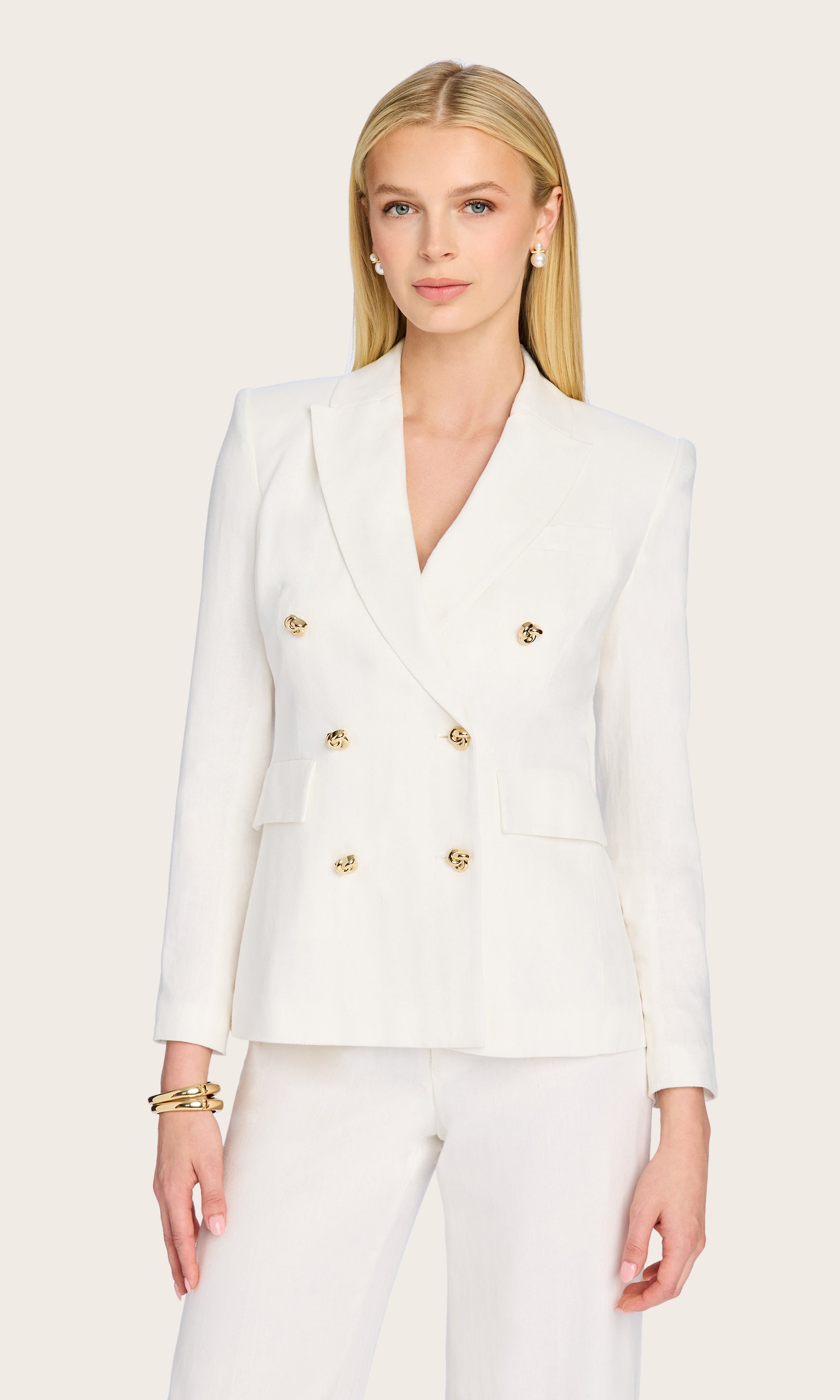 Front-facing image of the Arielle Linen Blazer styled with matching white trousers for a crisp tailored look.