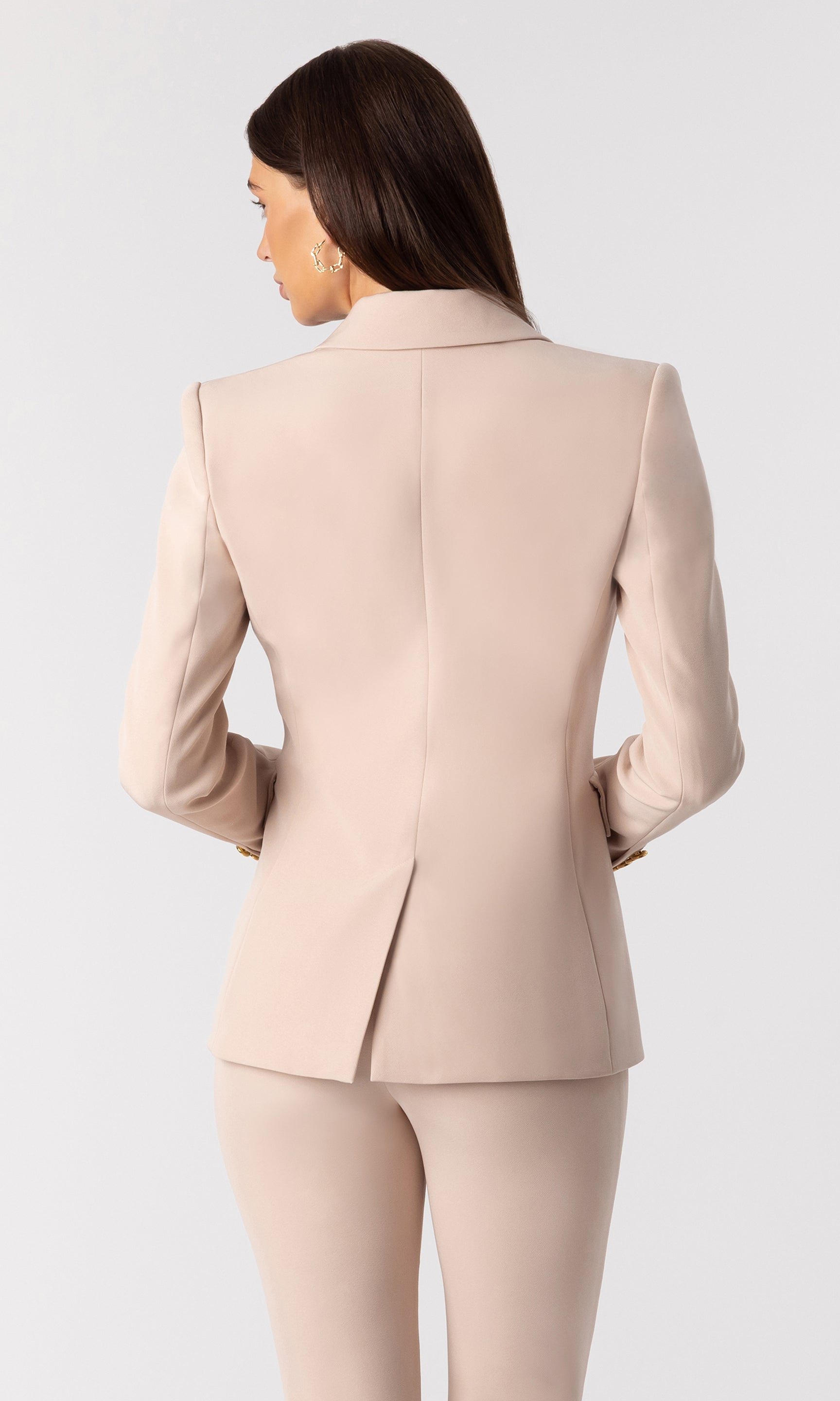 back view image of model wearing the Arielle crepe blazer in latte with matching latte trousers