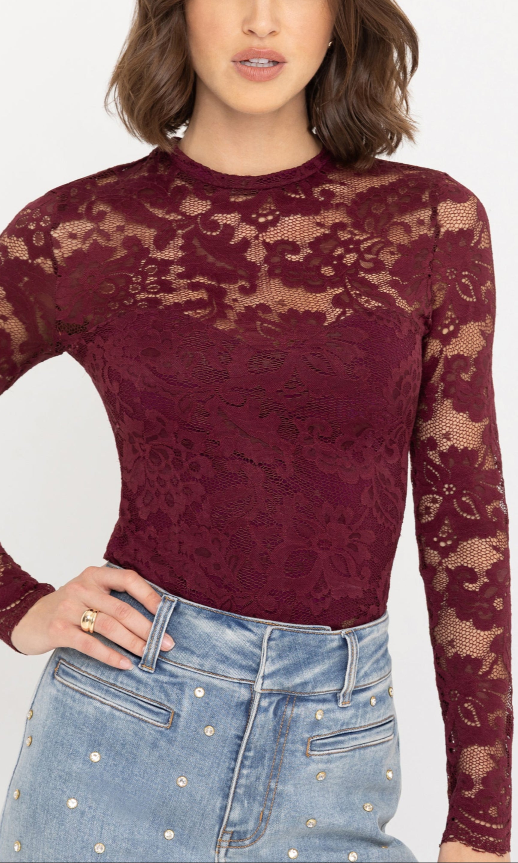 Close-up front view of the Clayton Lace Top in burgundy, highlighting the sheer lace detailing and high neckline.