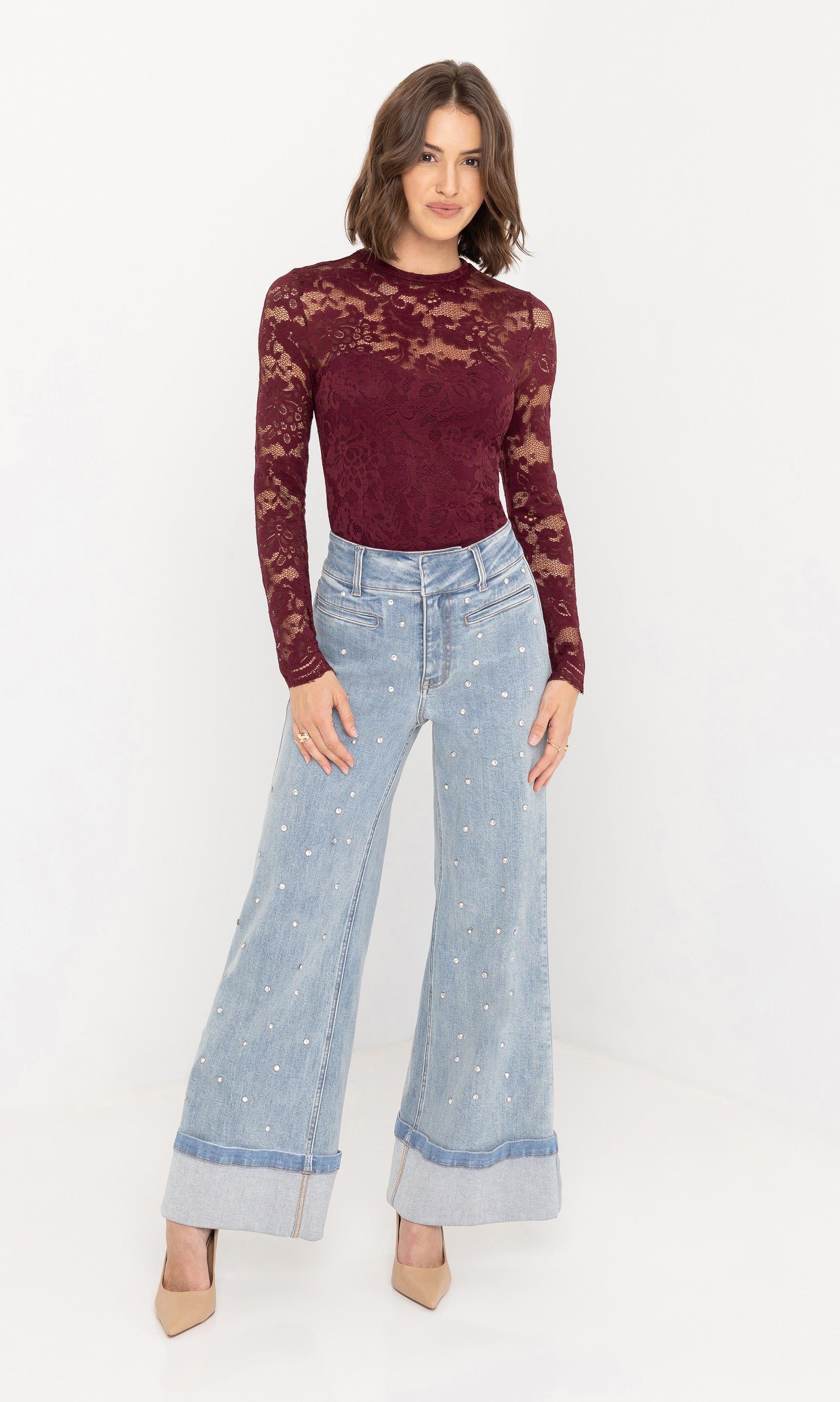 Full body studio shot of the Raquel Crystal Stud Jeans with a burgundy knit top and nude heels.