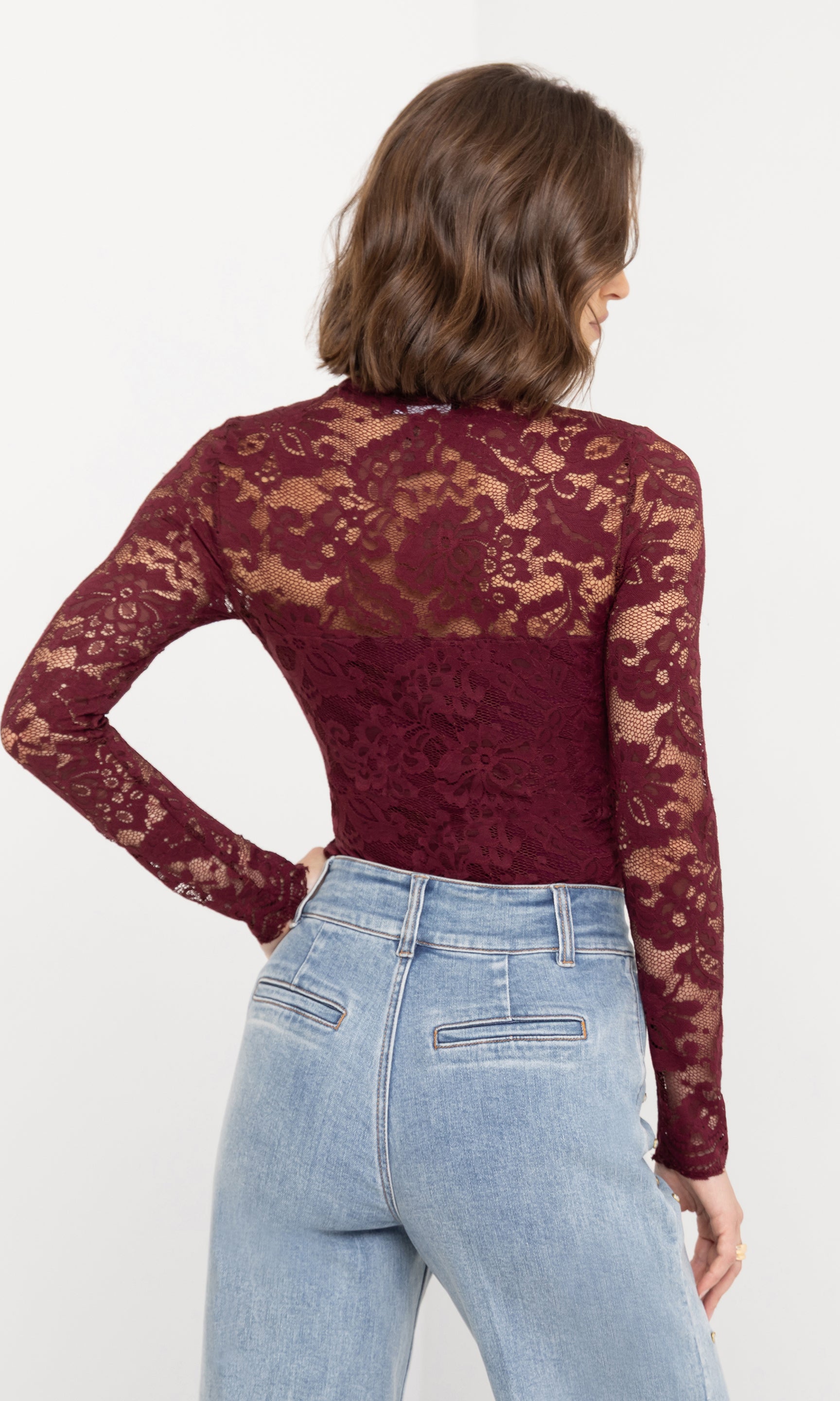 Rear view of the Clayton Lace Top in burgundy, showing the intricate lace pattern and fitted silhouette.
