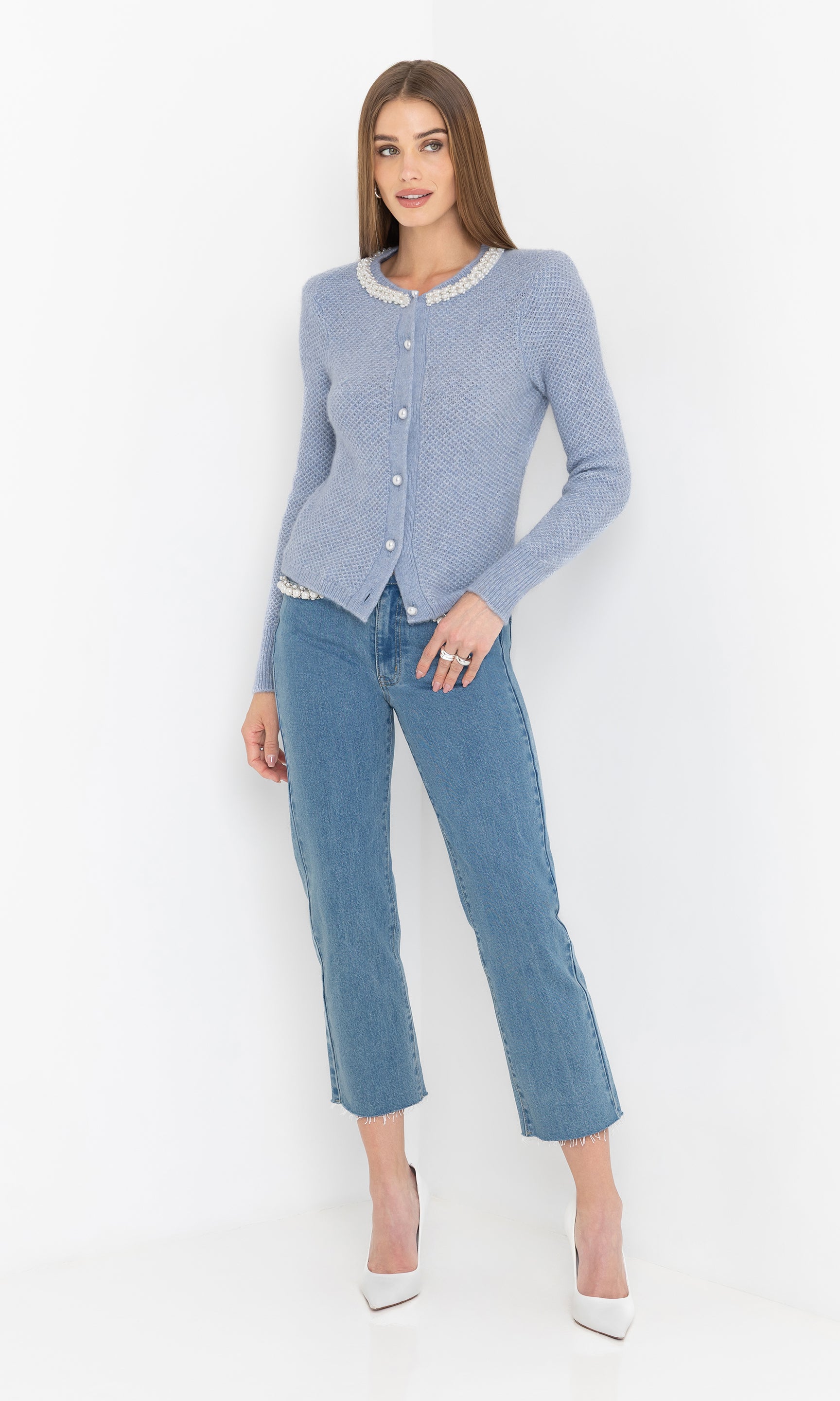 Full body front view of the Clove Cardigan in soft blue, paired with light blue straight-leg jeans.