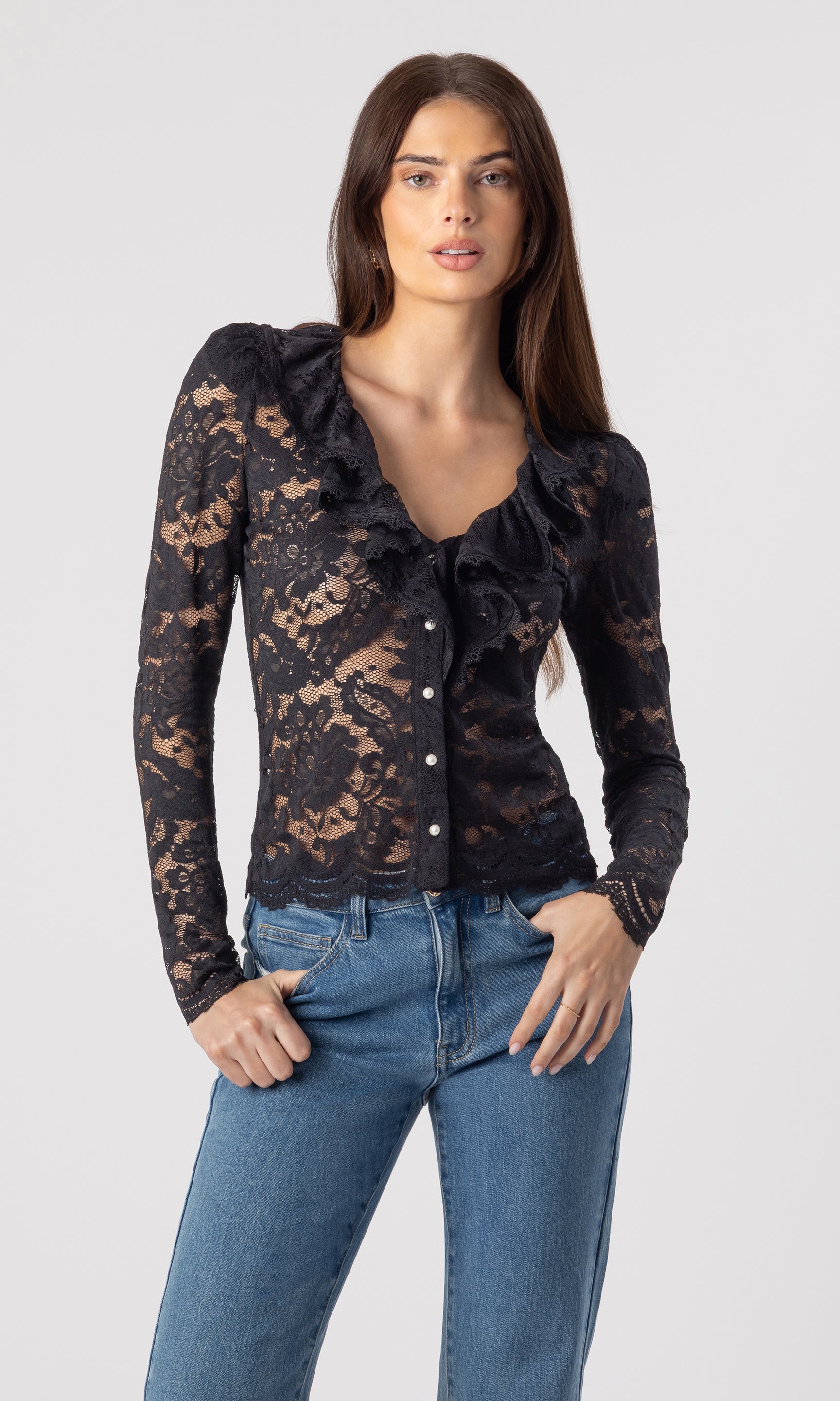 image of model wearing the black Corsa lace blouse paired with blue jeans