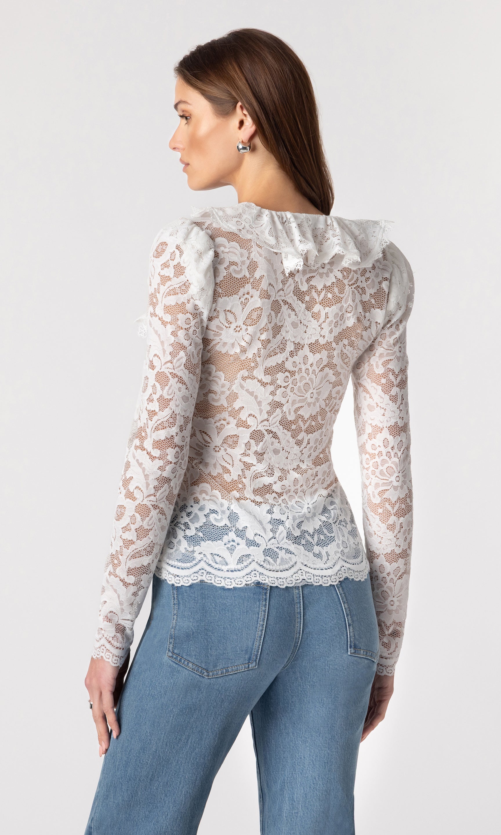 back view image of model wearing the Corsa lace top in white paired with blue jeans
