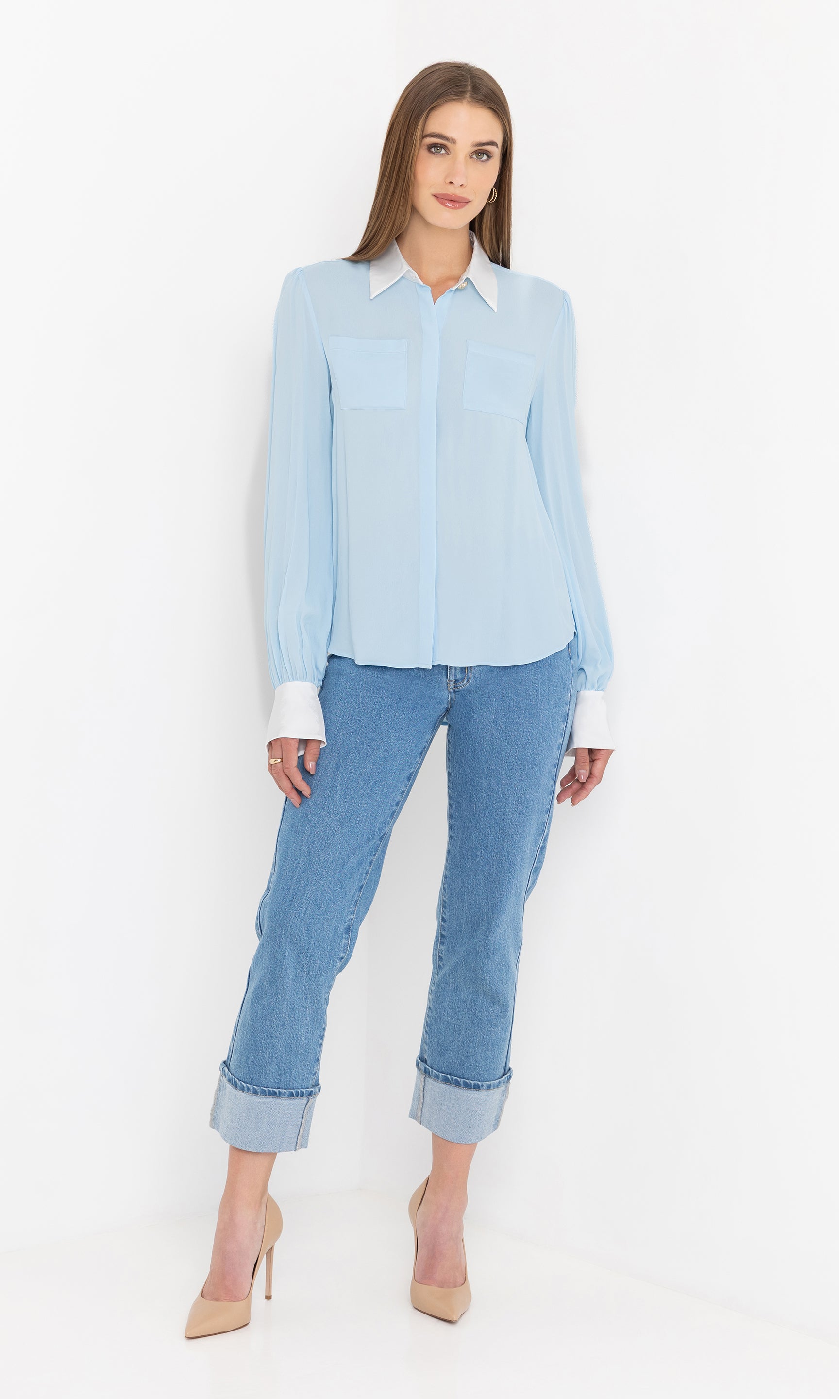 Full body view of the blouse paired with cropped jeans and nude heels for a polished finish.