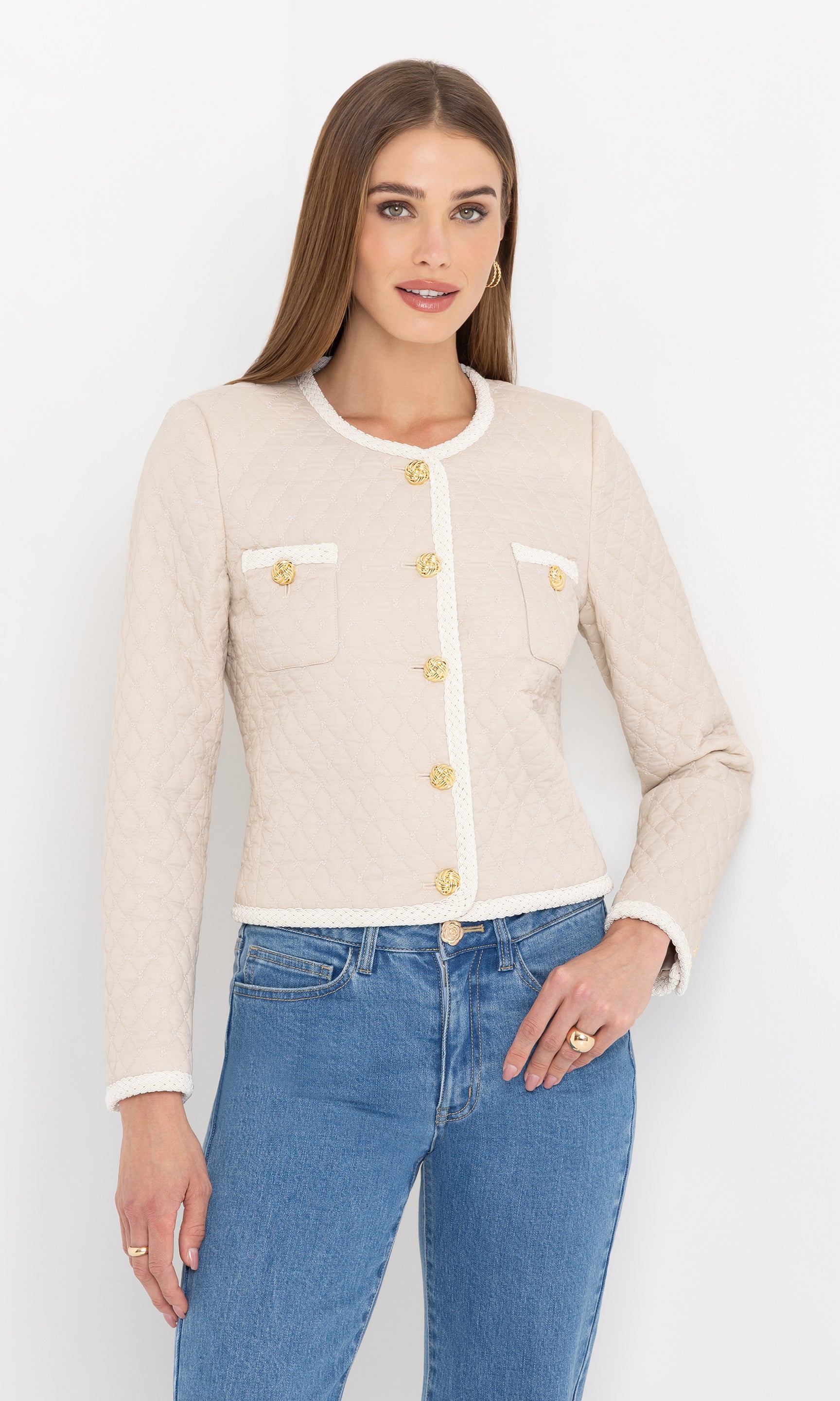 Full body view with hands in pockets, pairing the cream Everie Quilted Jacket with casual denim.