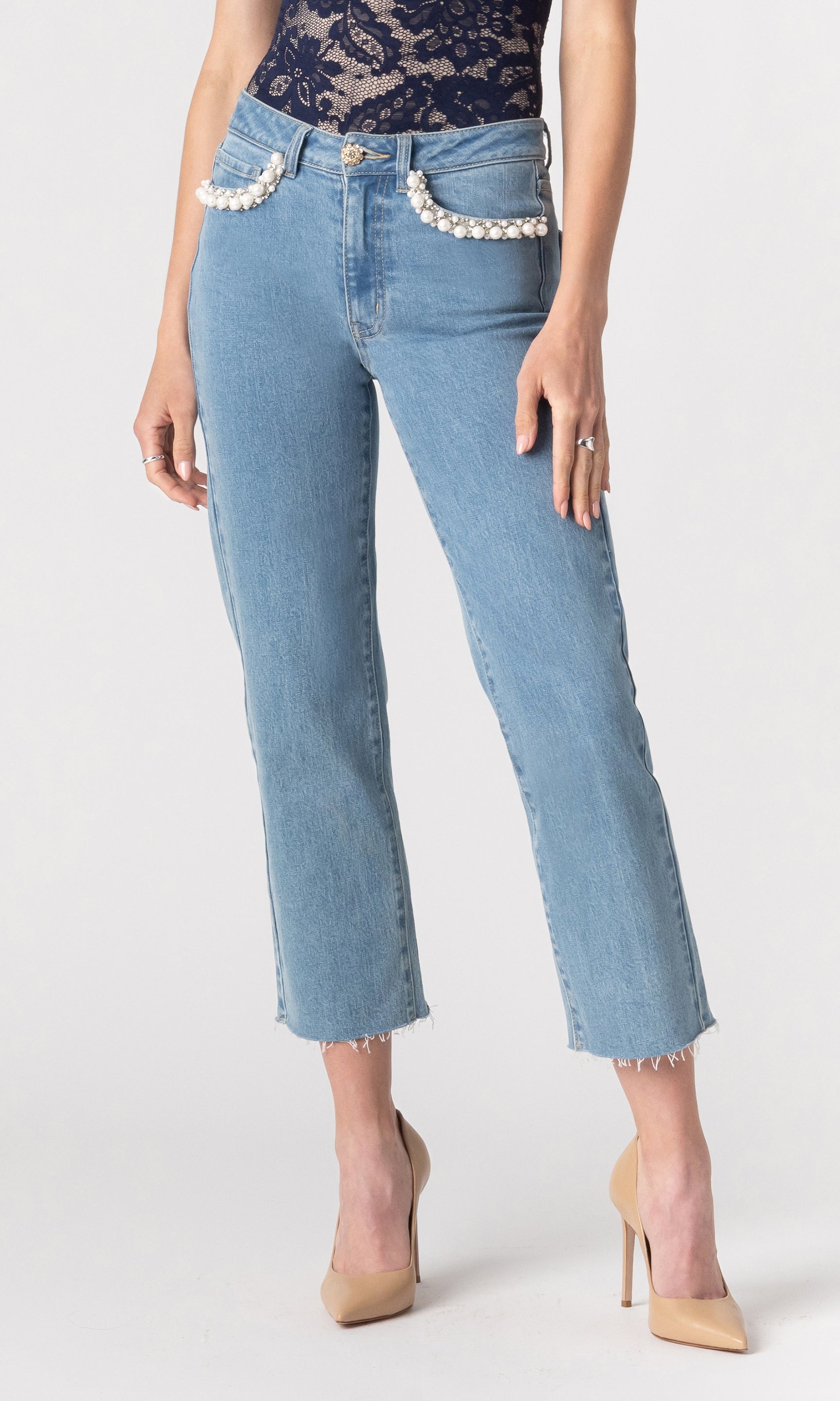cropped image of model wearing the Baylor jeans paired with a navy lace top and beige heels