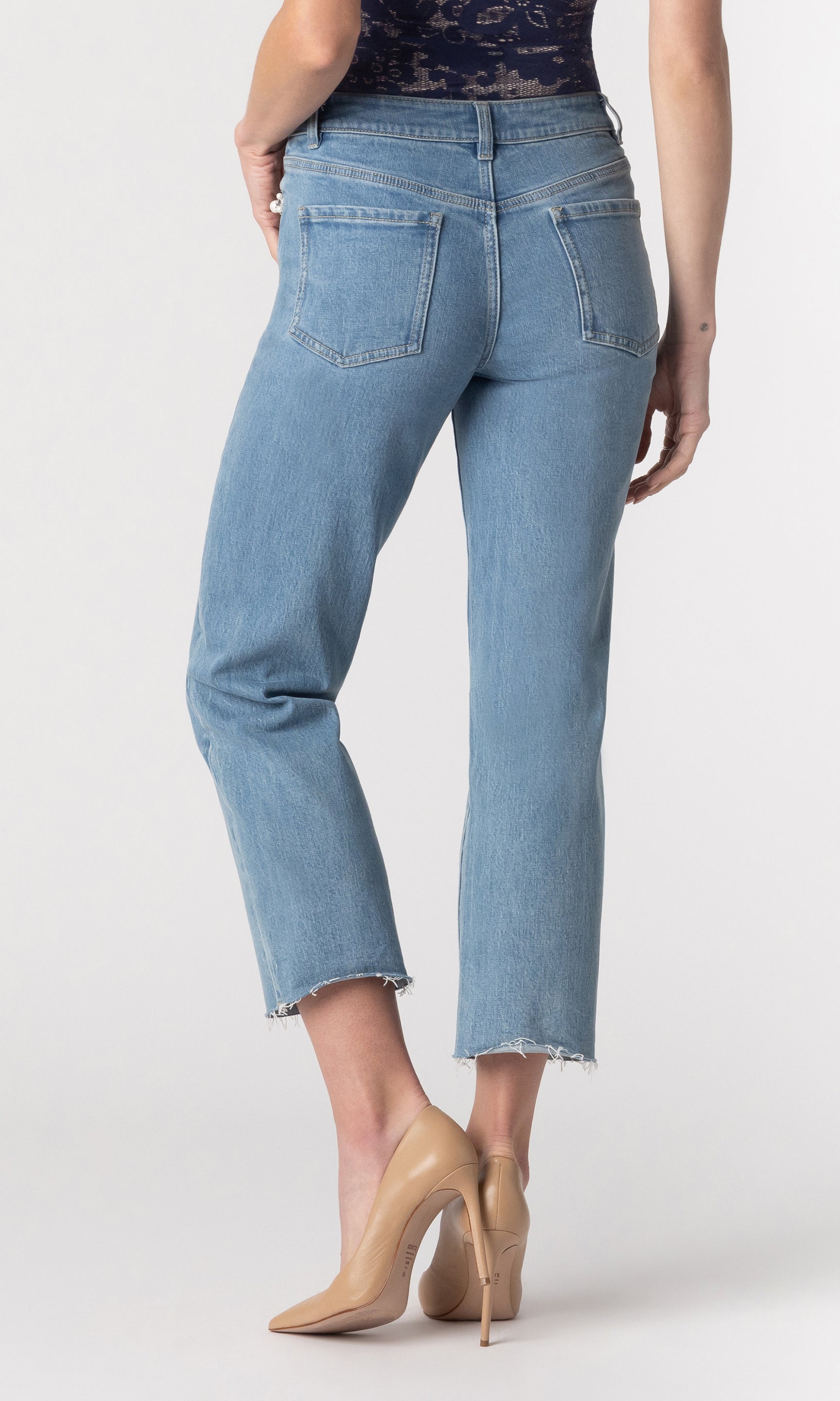 cropped back image of model wearing the Baylor jeans paired with a navy lace top and beige heels
