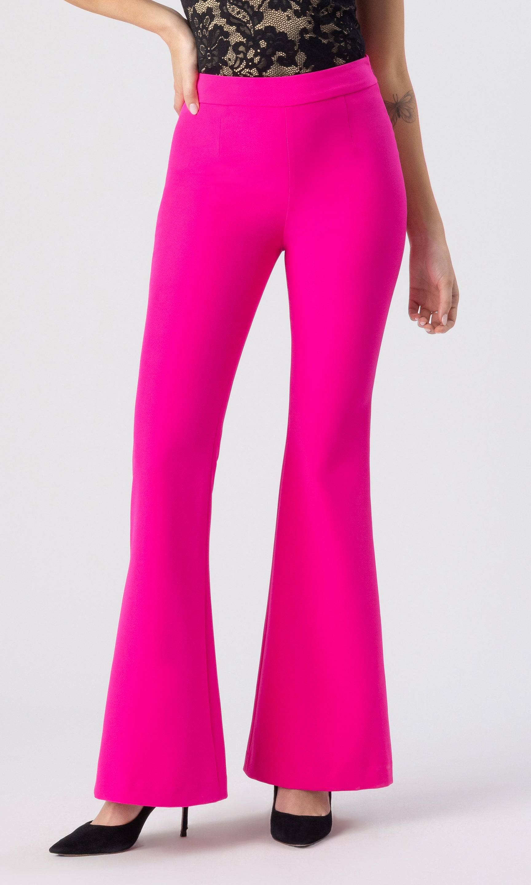 cropped image of model wearing the Wesley crepe pants in hot pink, paired with a black/beige lace top and black heels