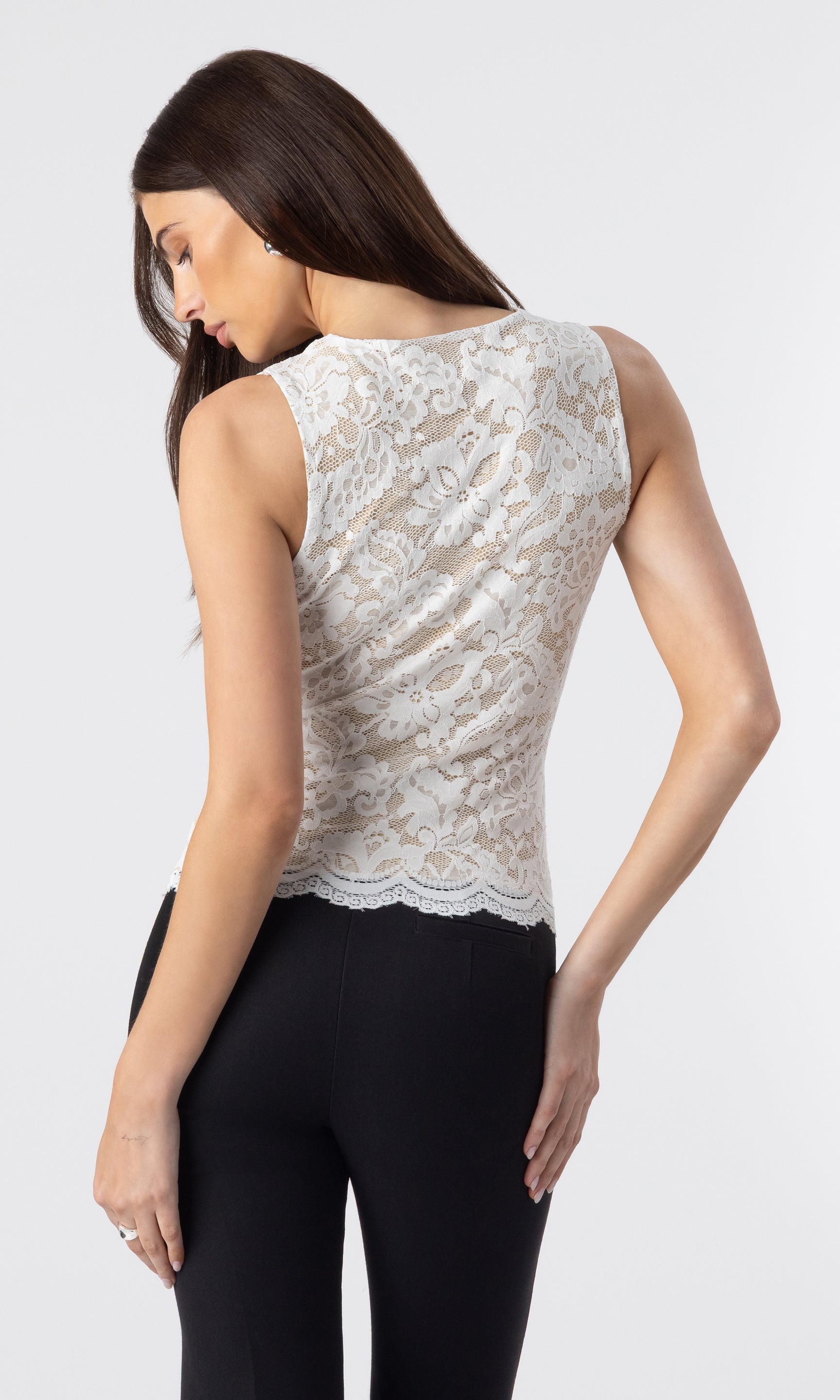 back view image of model wearing the Leila lace tank in white/beige paired with black crepe pants