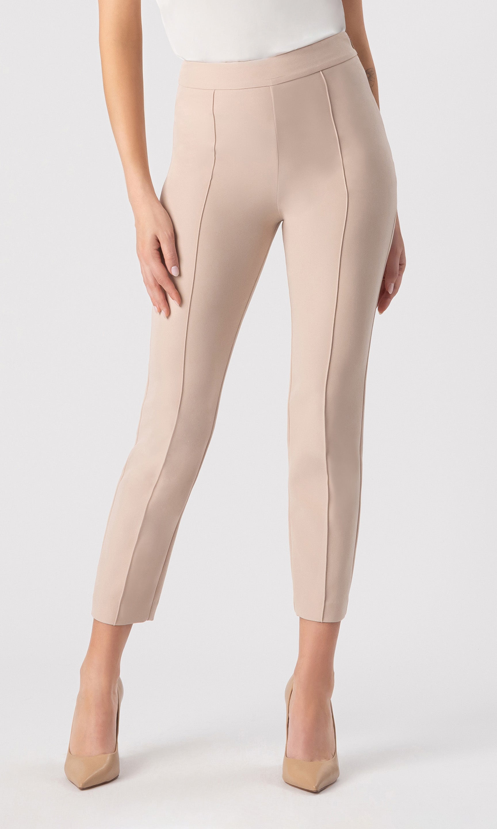 cropped image of model wearing the Lonny Crepe Pants in latter paired with a white top and beige heels