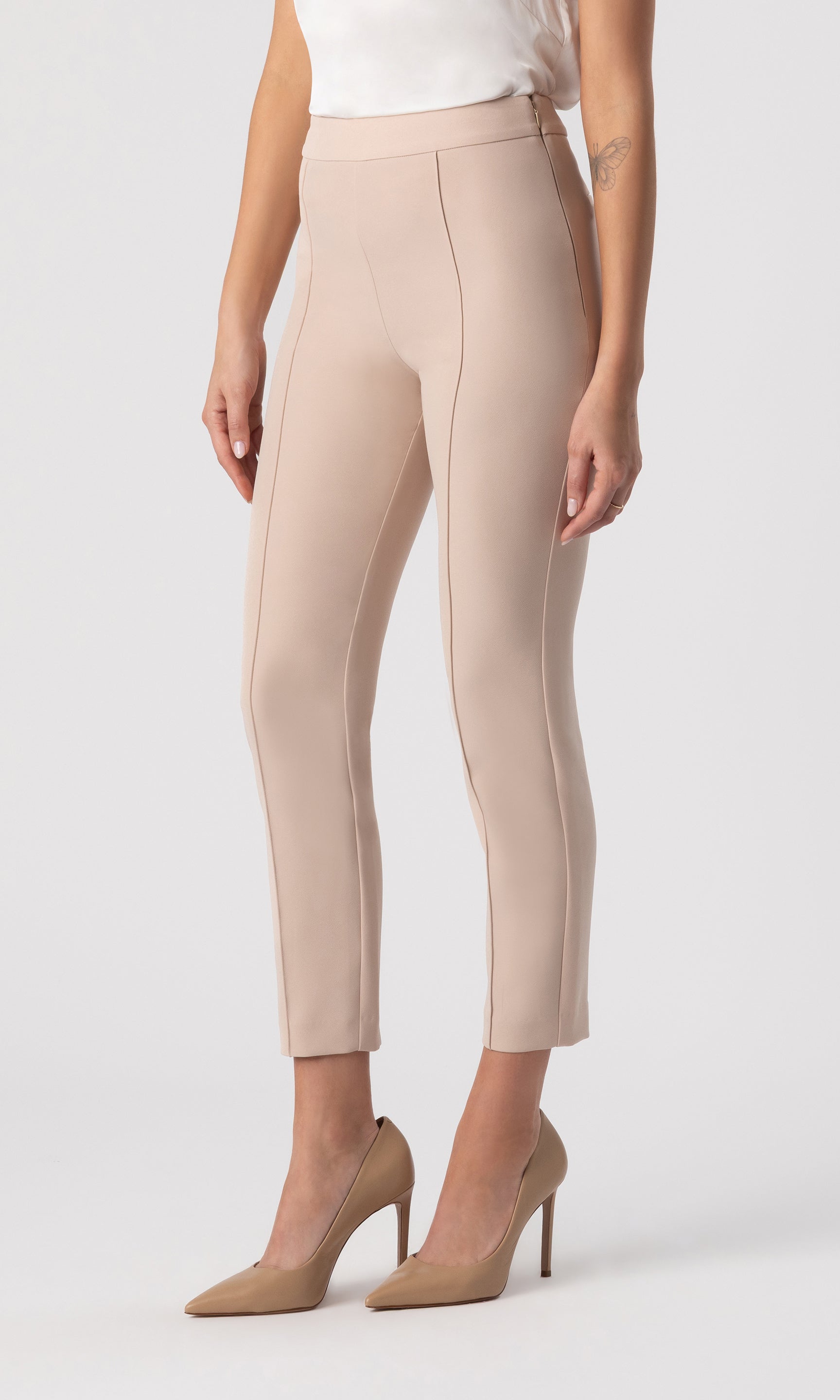 cropped 3/4 view image of model wearing the Lonny Crepe Pants in latter paired with a white top and beige heels