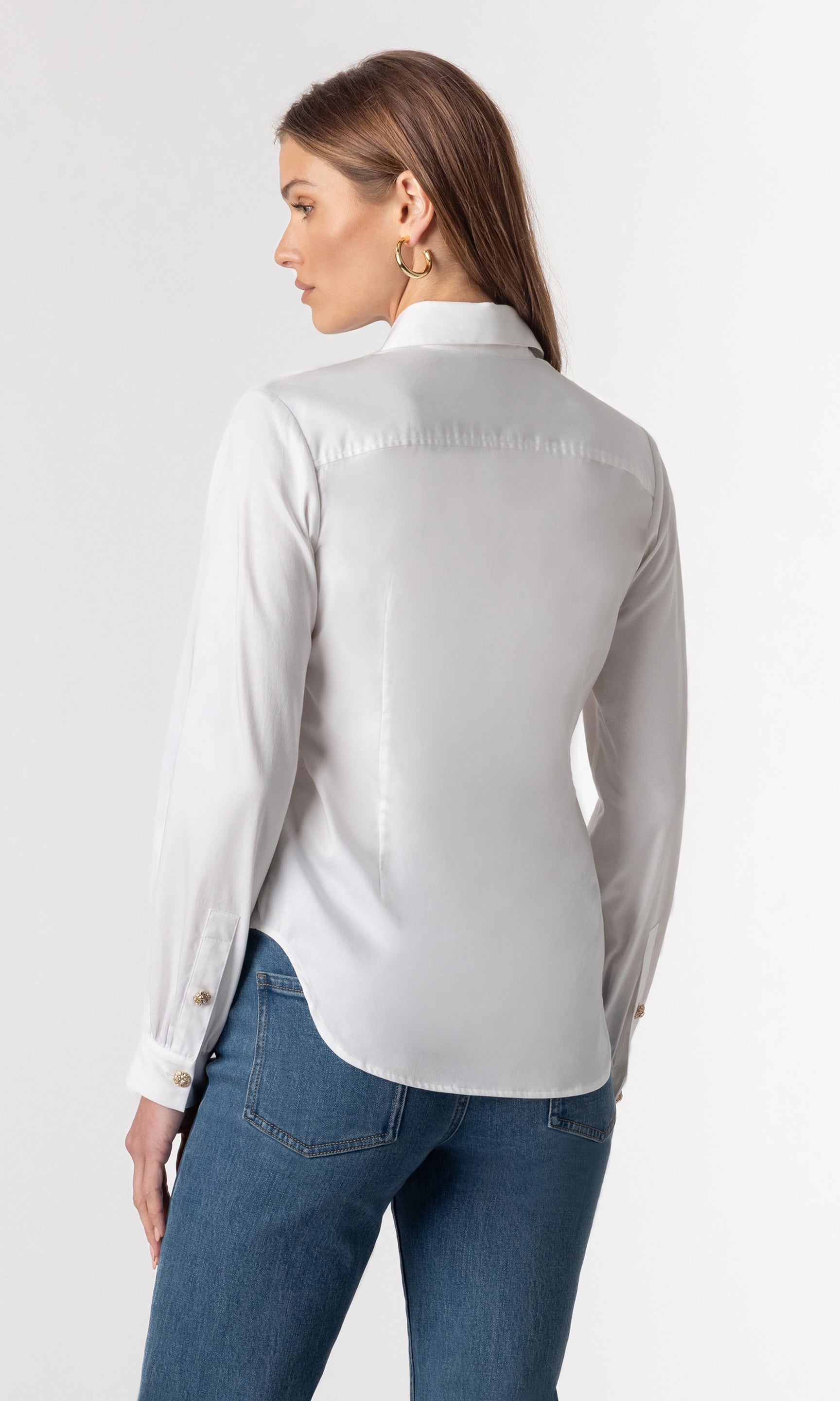 back view image of model wearing the Lonny button-down blouse paired with dark blue jeans