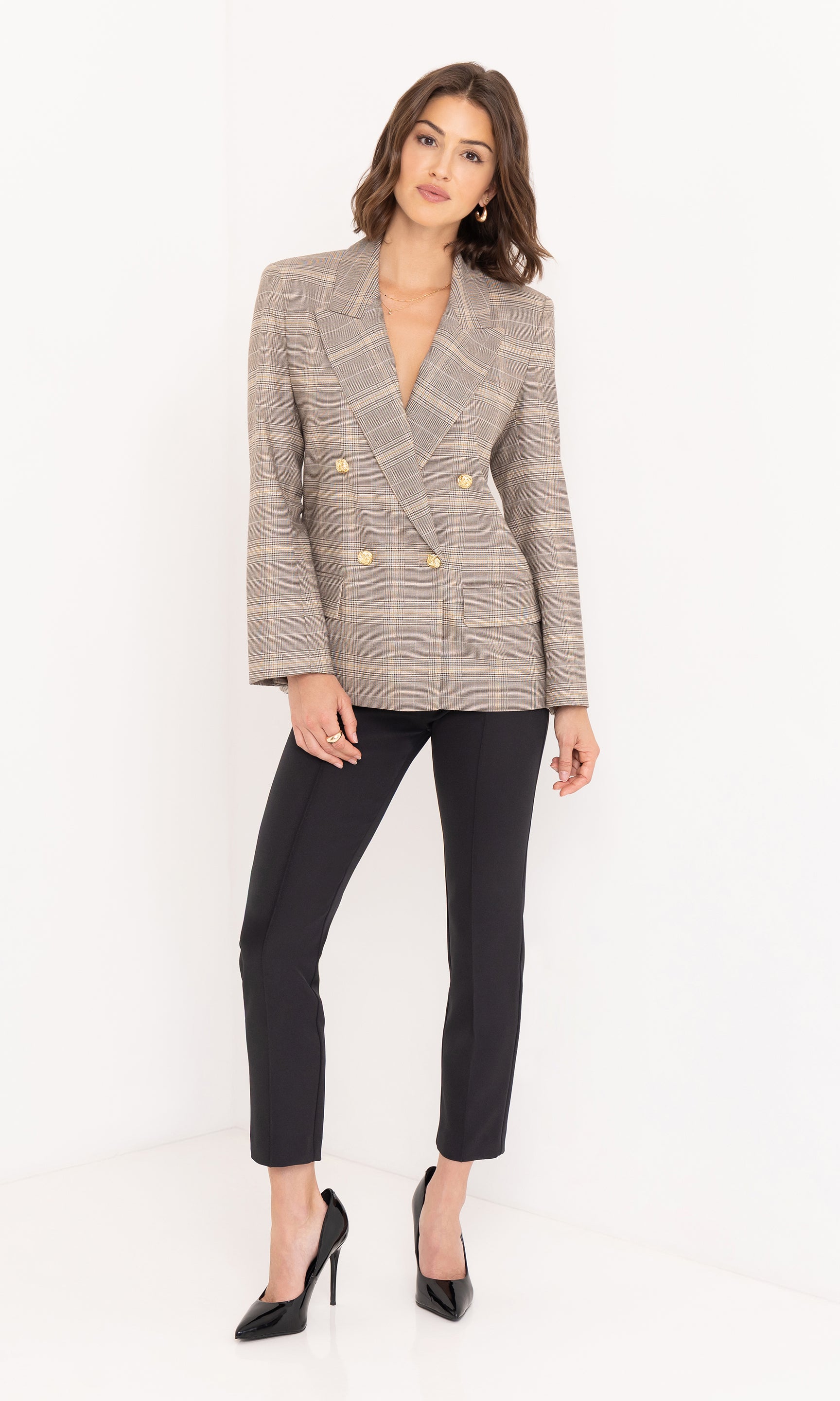 Full body front view of the blazer paired with black pants and heels.