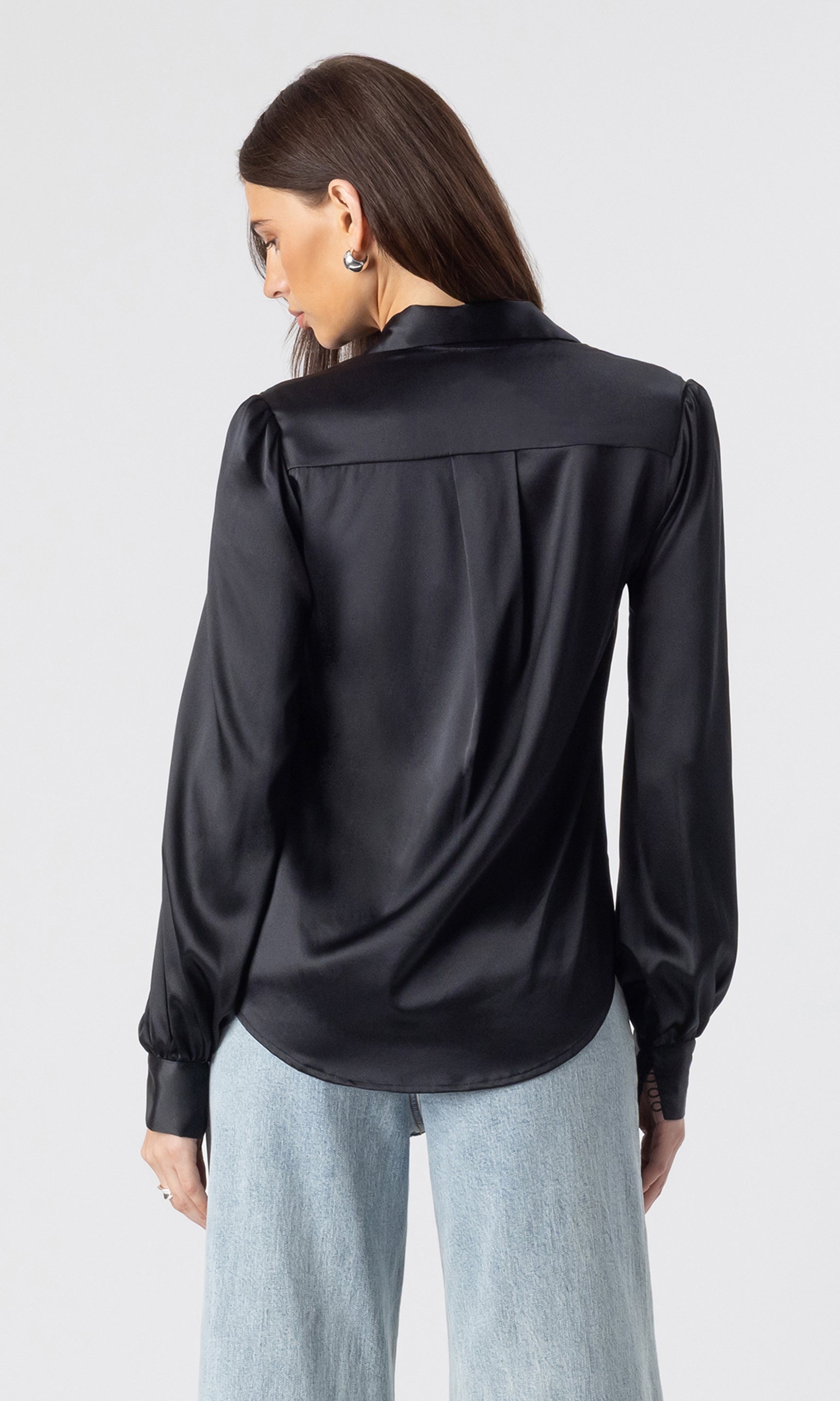 back view image of model wearing the Maxwell blouse in black paired with light blue jeans