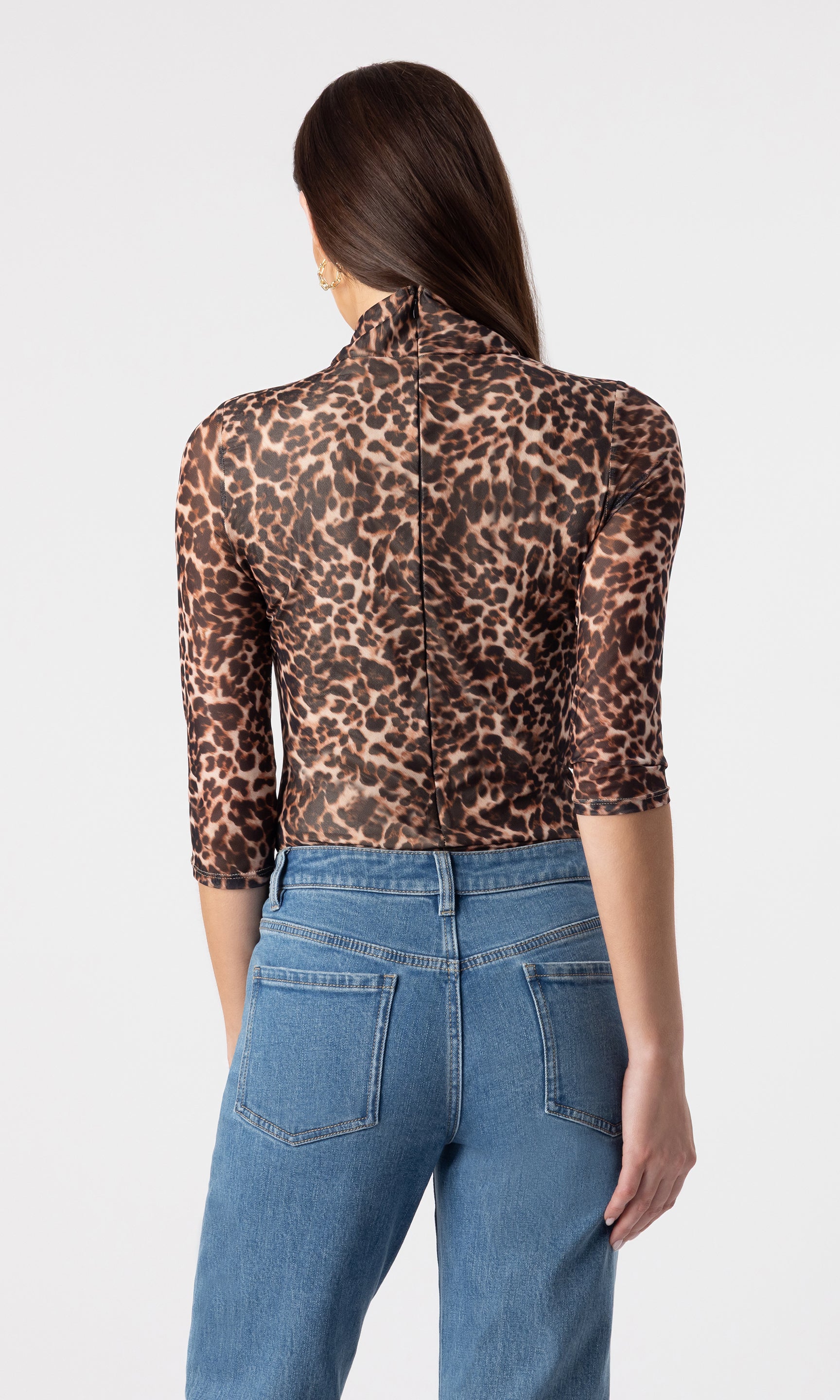 back view image of model wearing the Milo mesh bodysuit in a leopard print paired with dark blue jeans