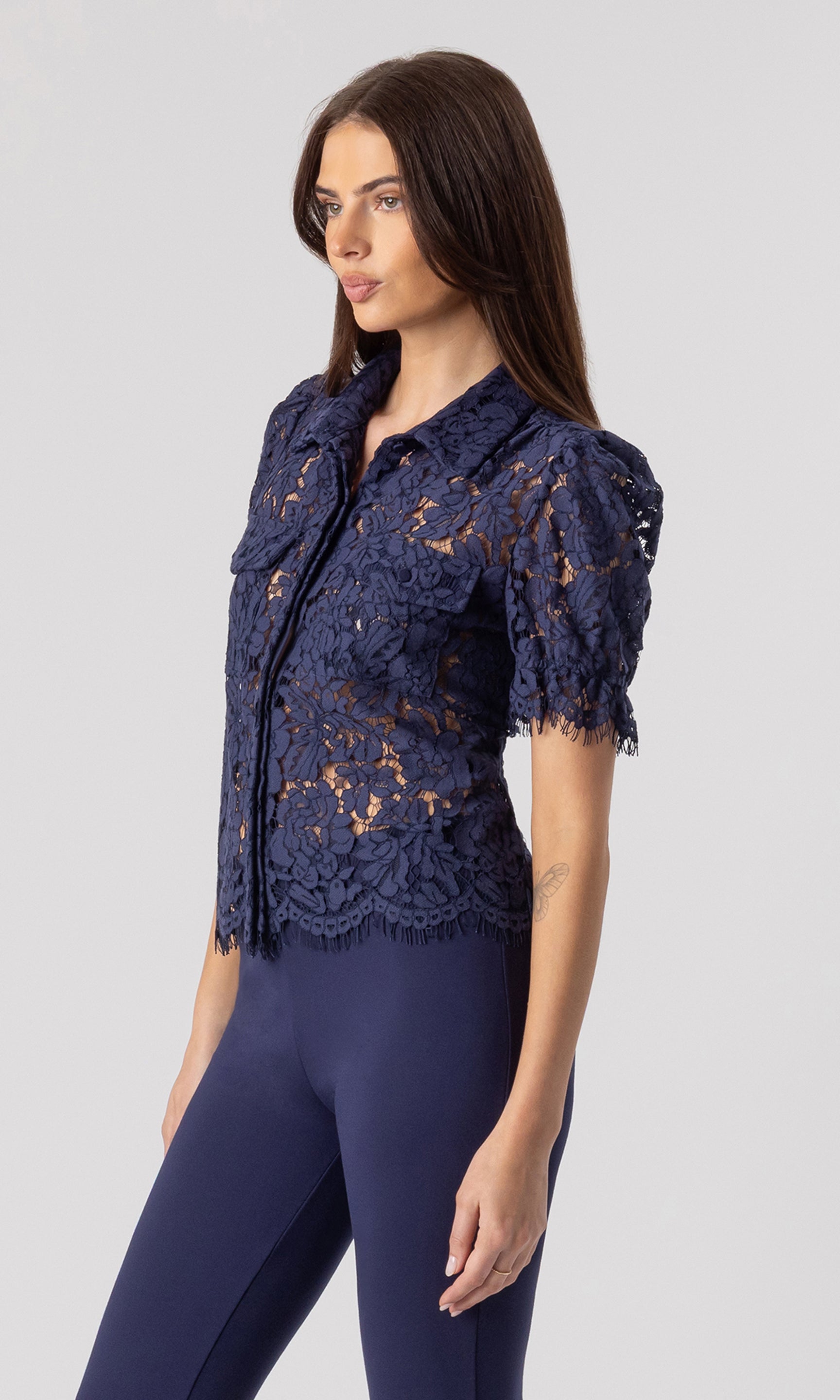 side view image of model wearing the Mina lace shirt in navy paired with matching navy leggings