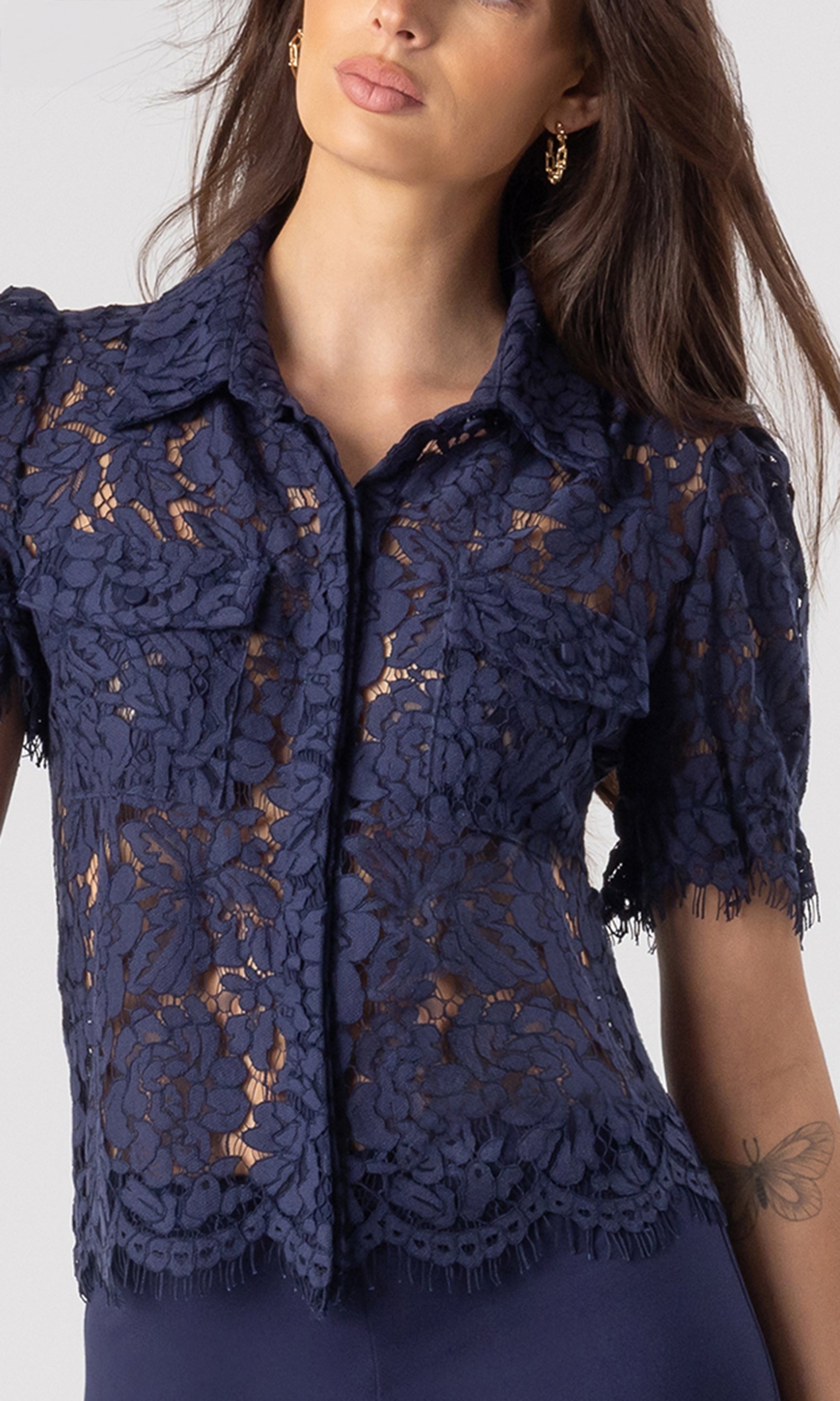 zoomed in image of model wearing the Mina lace shirt in navy showcasing the delicate lace details all over, paired with matching navy leggings