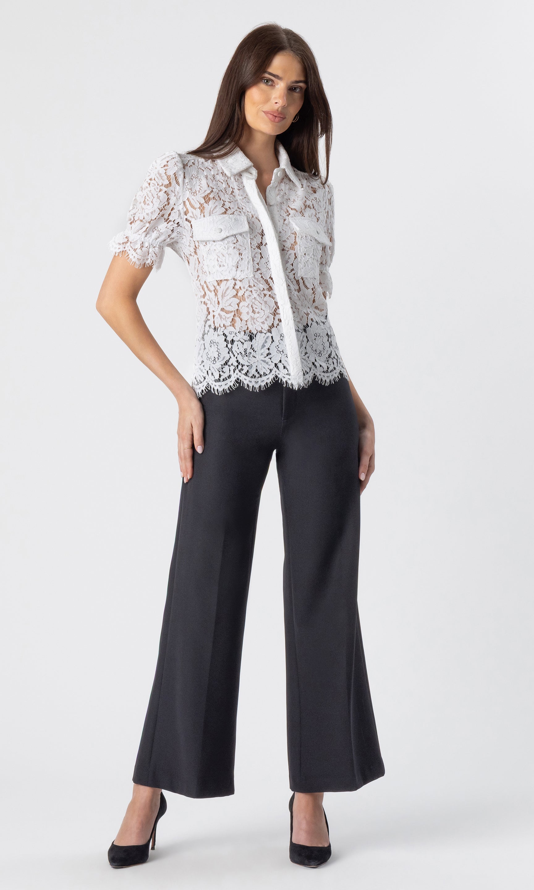 full body image of model wearing a white lace top paired with the Rayne crepe wide-leg pants with black heels