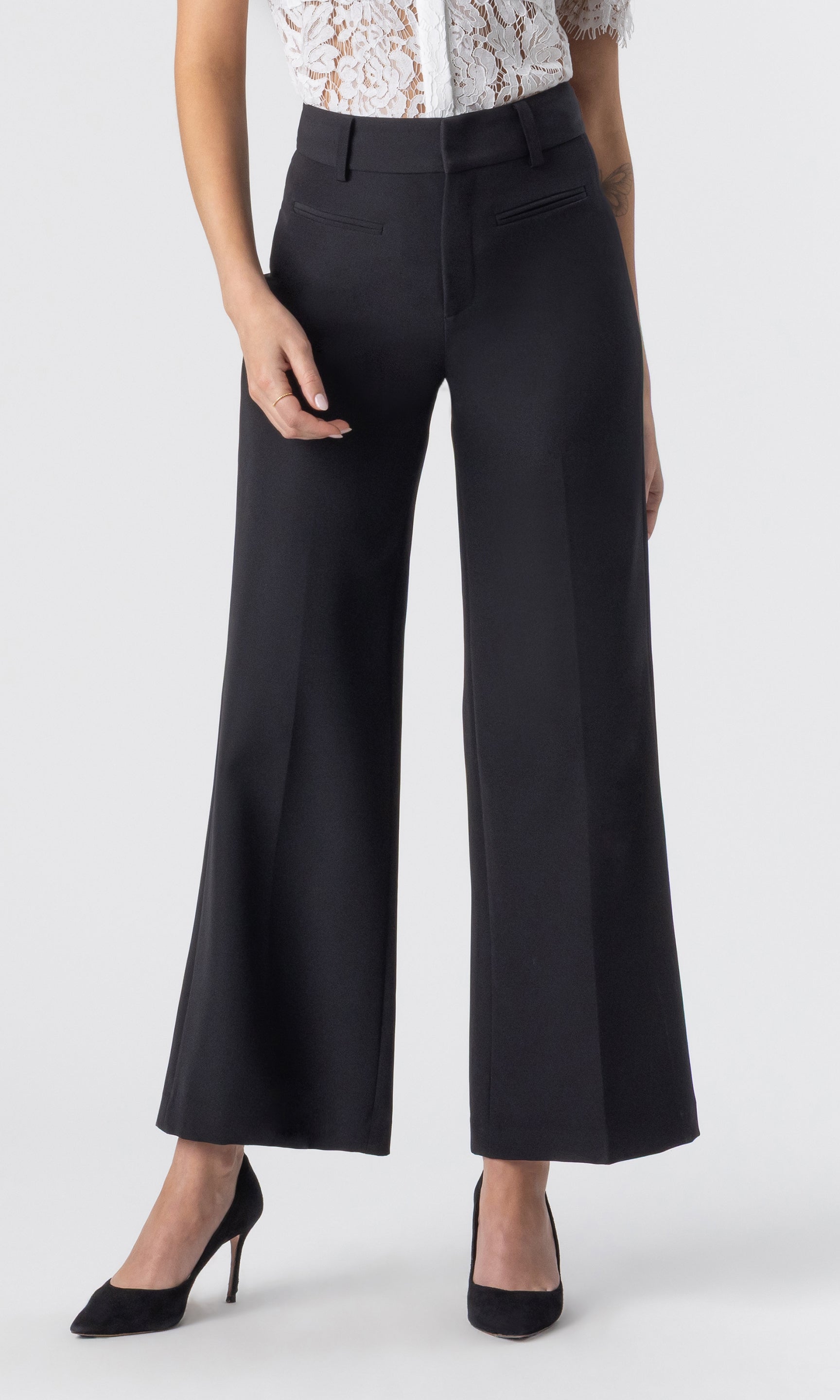 cropped image of model wearing a white lace top paired with the Rayne crepe wide-leg pants with black heels