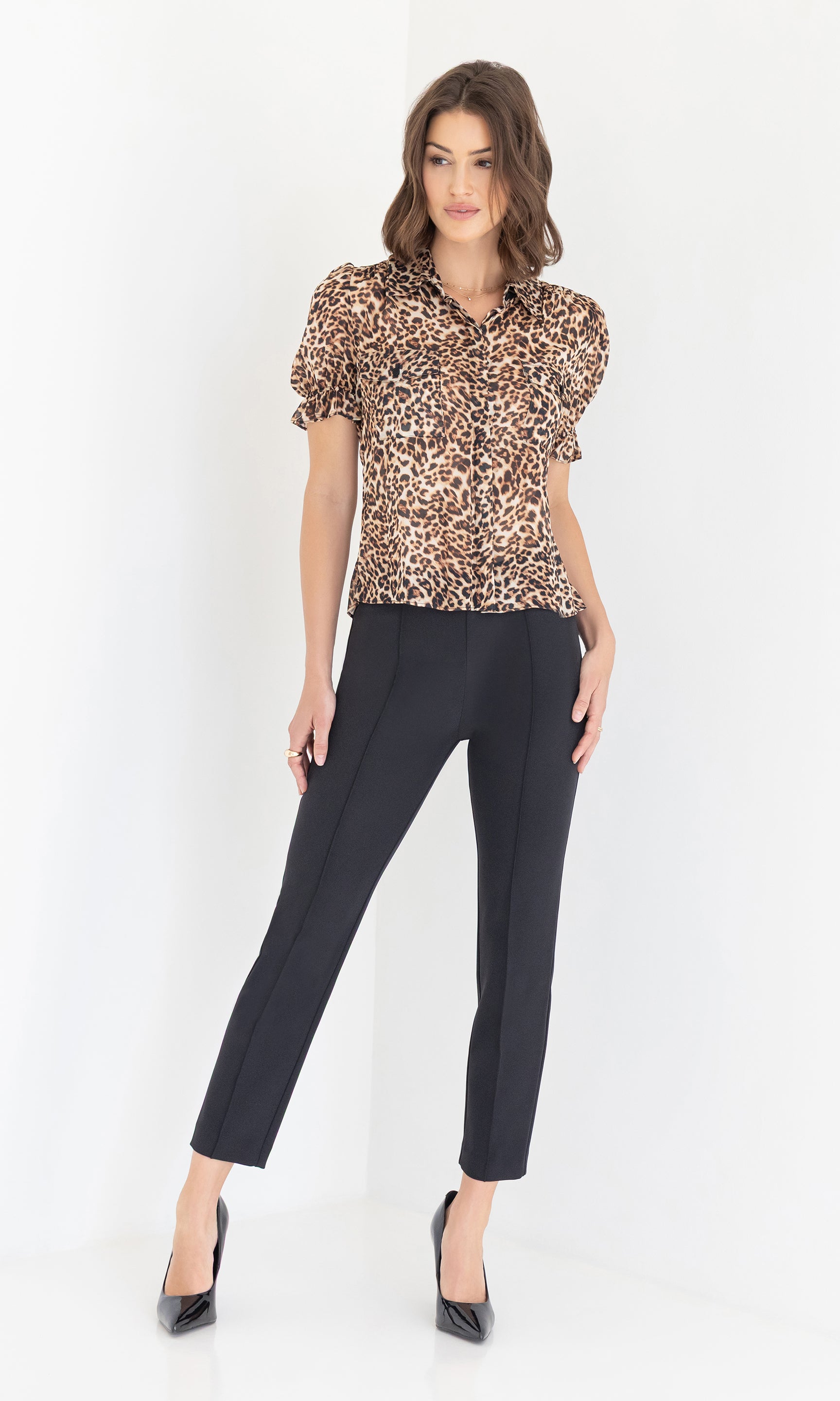Full body view of the model wearing the Mina Leopard Georgette Shirt with black trousers and heels, standing against a white background.