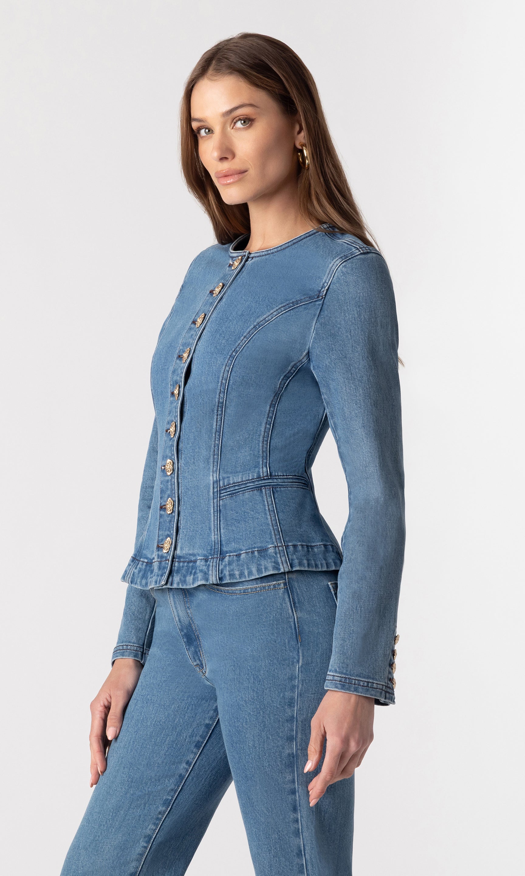 side view image of model wearing the Ophelia blue denim jacket paired with matching blue denim jeans