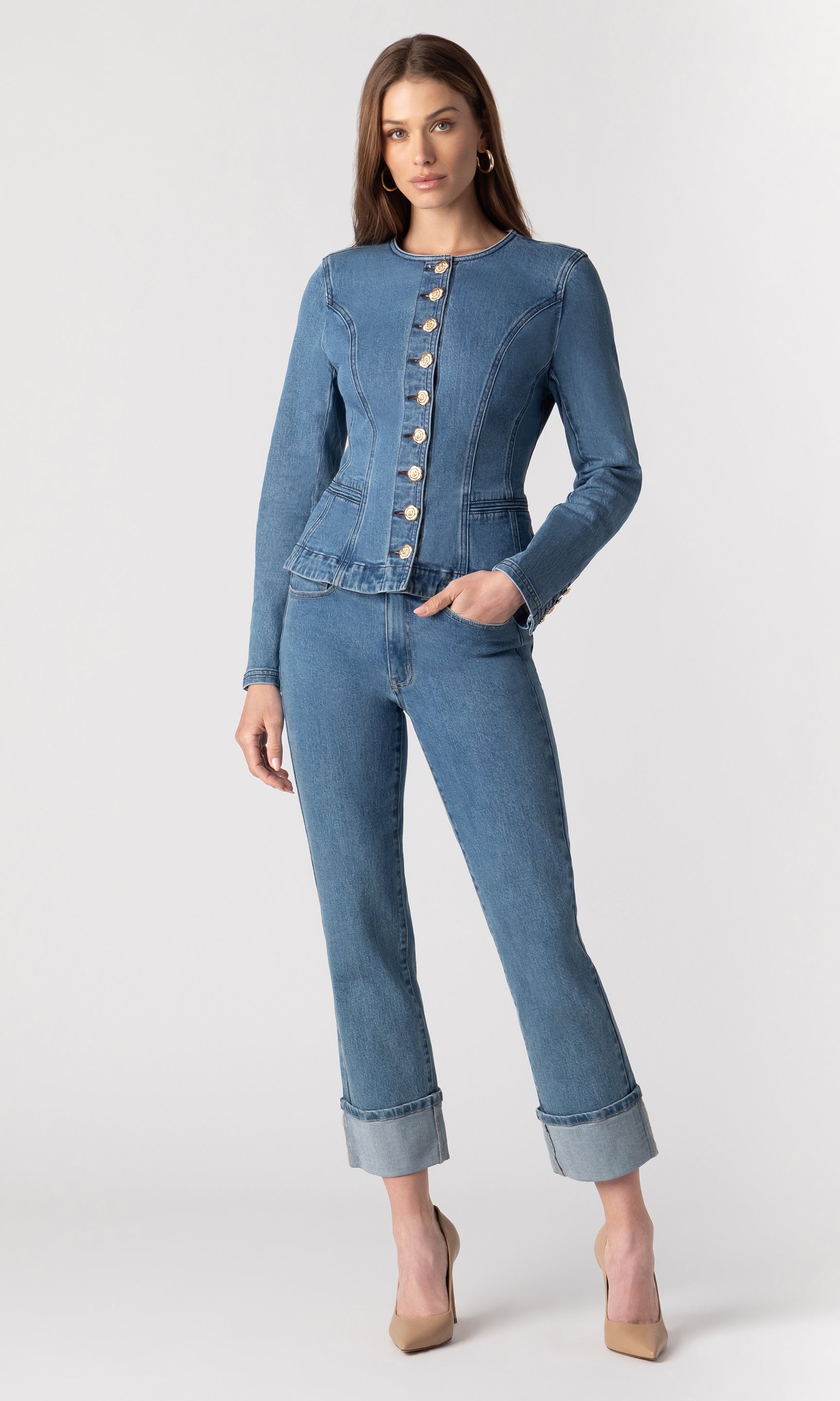 full body image of model wearing the Ophelia blue denim jacket paired with matching blue denim jeans and beige heels