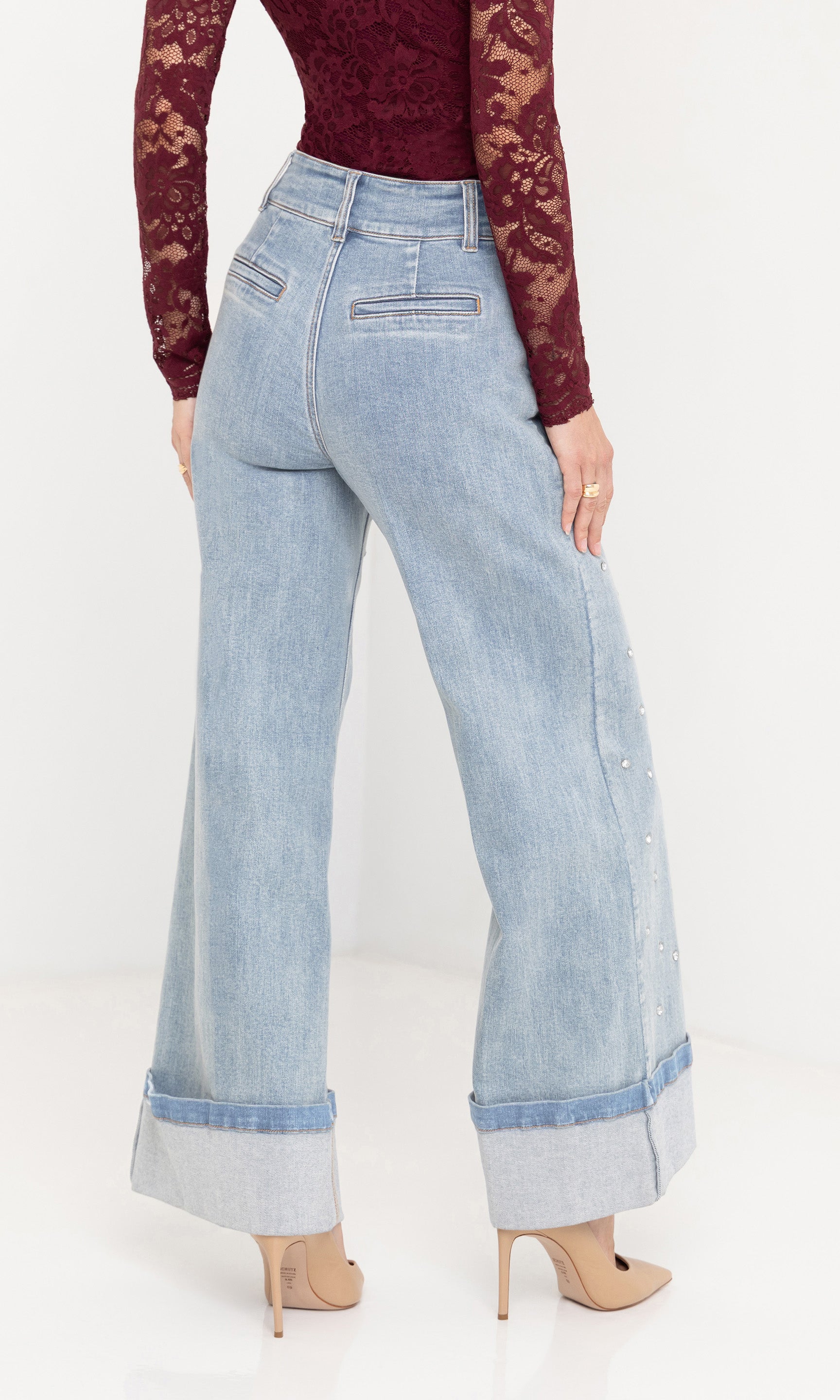 back view studio shot of the Raquel Crystal Stud Jeans with a burgundy knit top and nude heels.