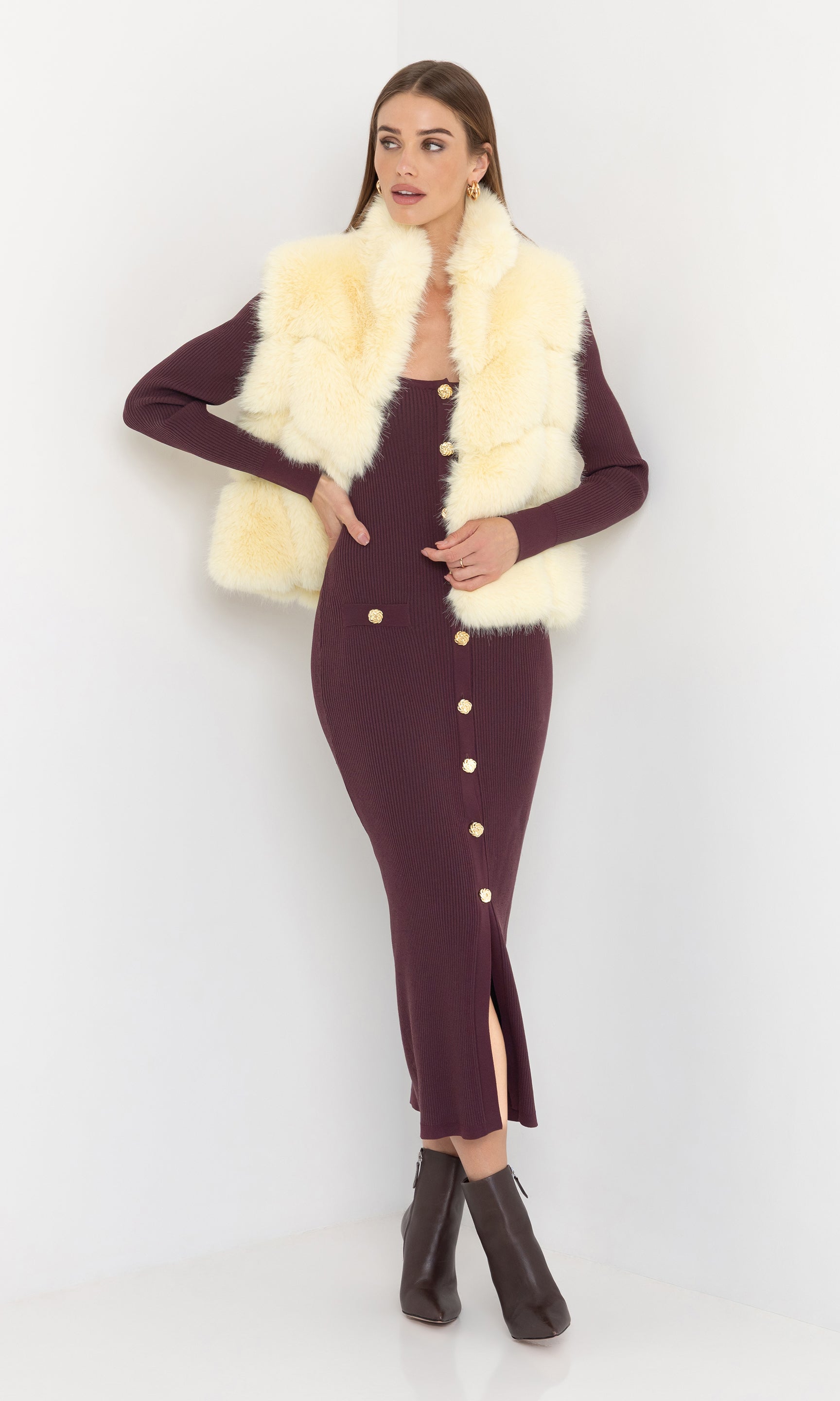 Full body front view of Rosario Faux Fur Vest in cream, paired with a fitted burgundy dress and heels.