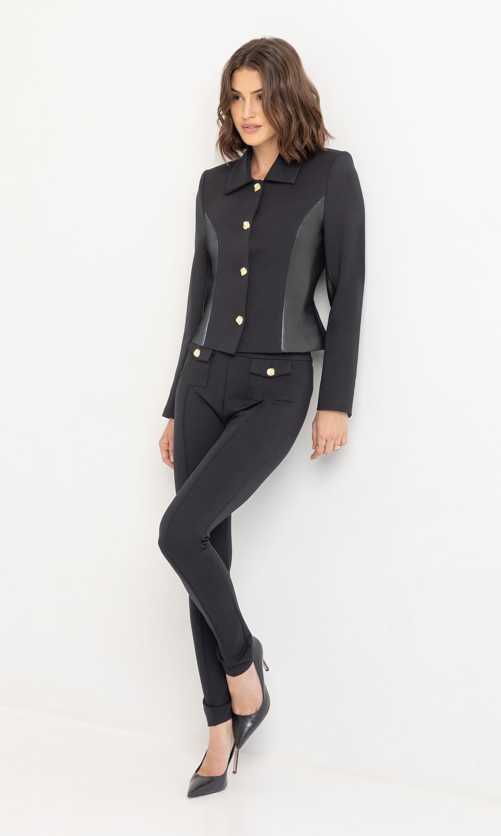 Angled view of Roy Ponte Leggings showing the fitted cut and ankle-length design paired with classic heels.