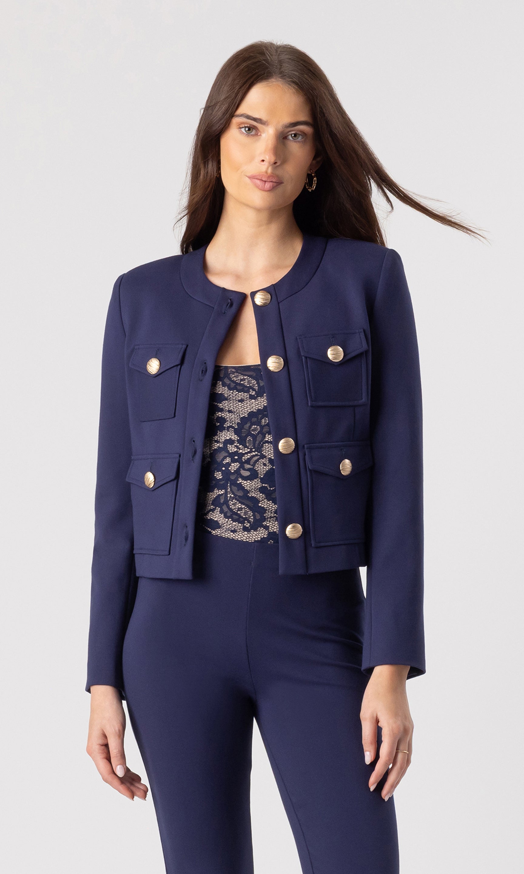 image of model wearing the Siena Ponte Jacket in navy over a navy/beige tank bodysuit and paired with navy leggings