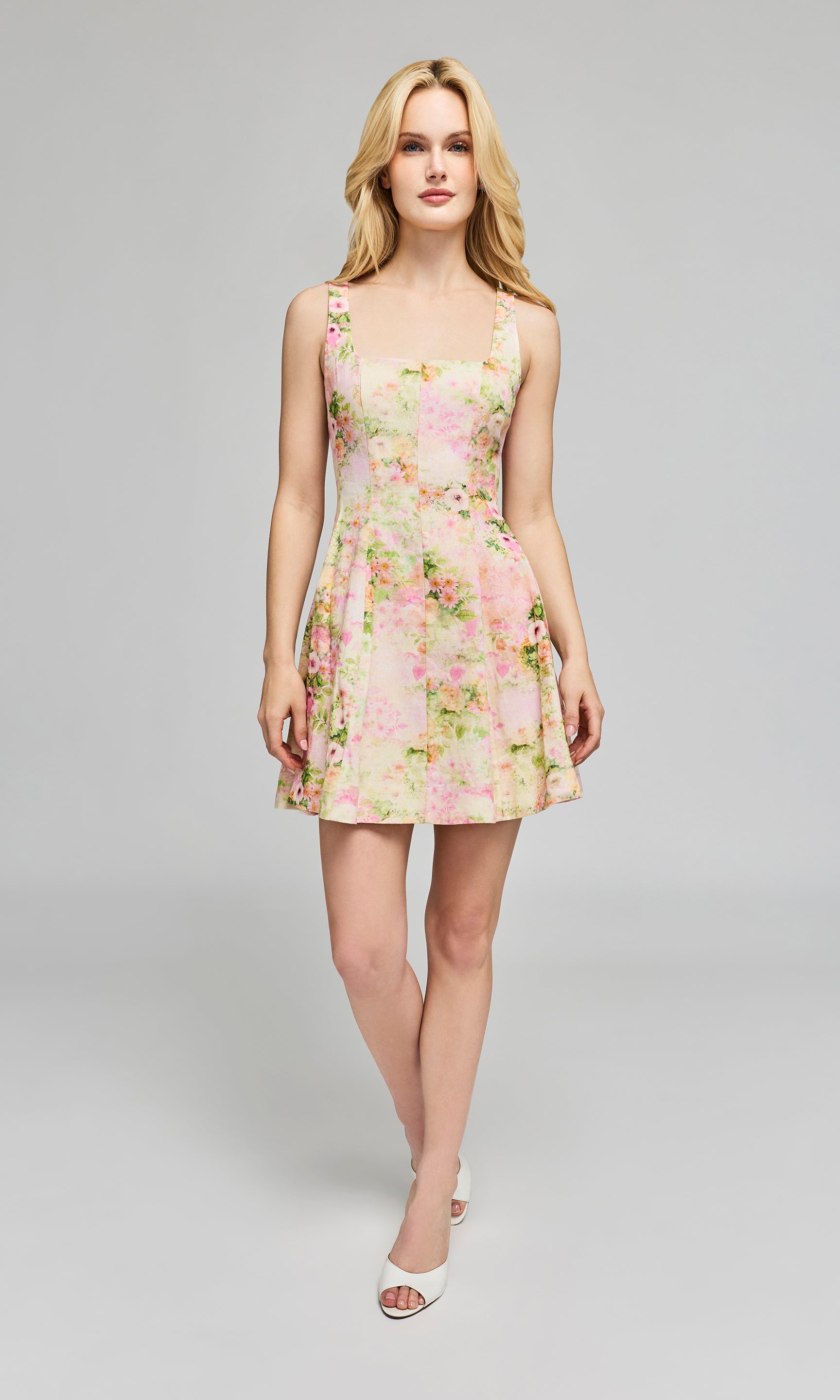 Woman wearing a floral dress on a gray background